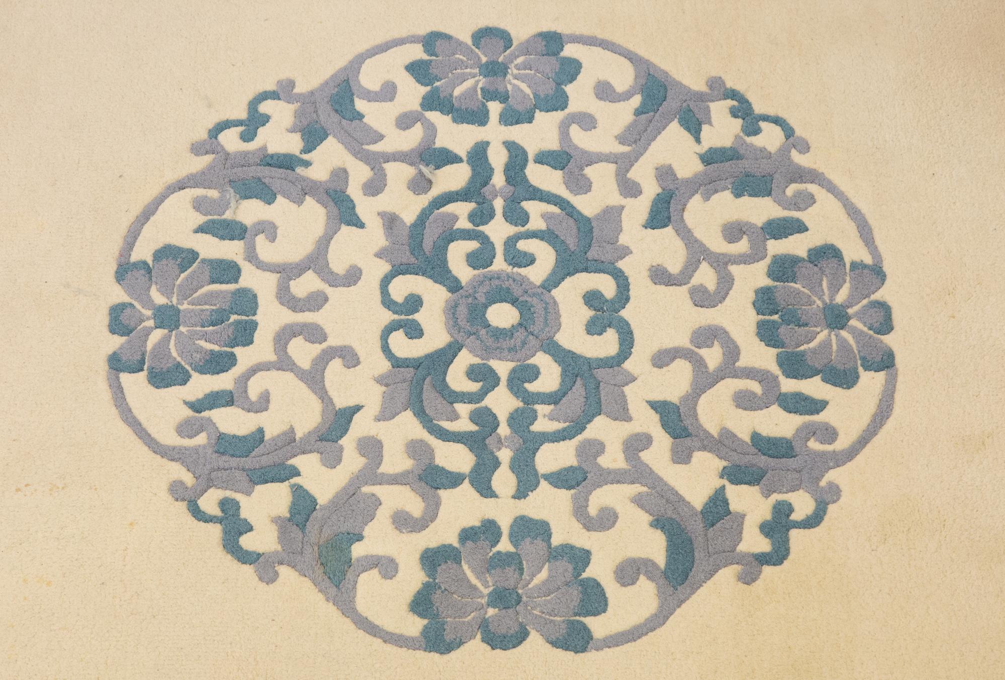 An Indian Blue and Ivory Chinese Style Wool Rug