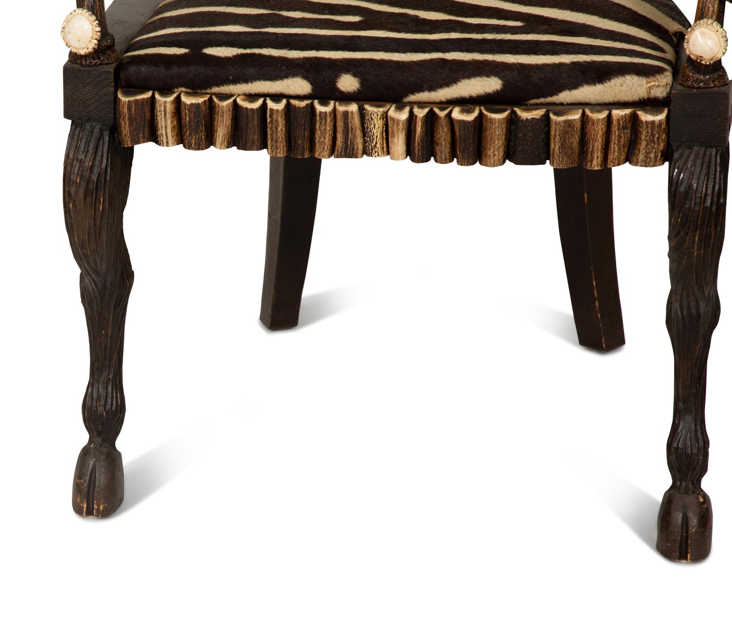 A Pair of Stag Antler Arm Chairs with Zebra Hide Upholstery Attributed to Anthony Redmile