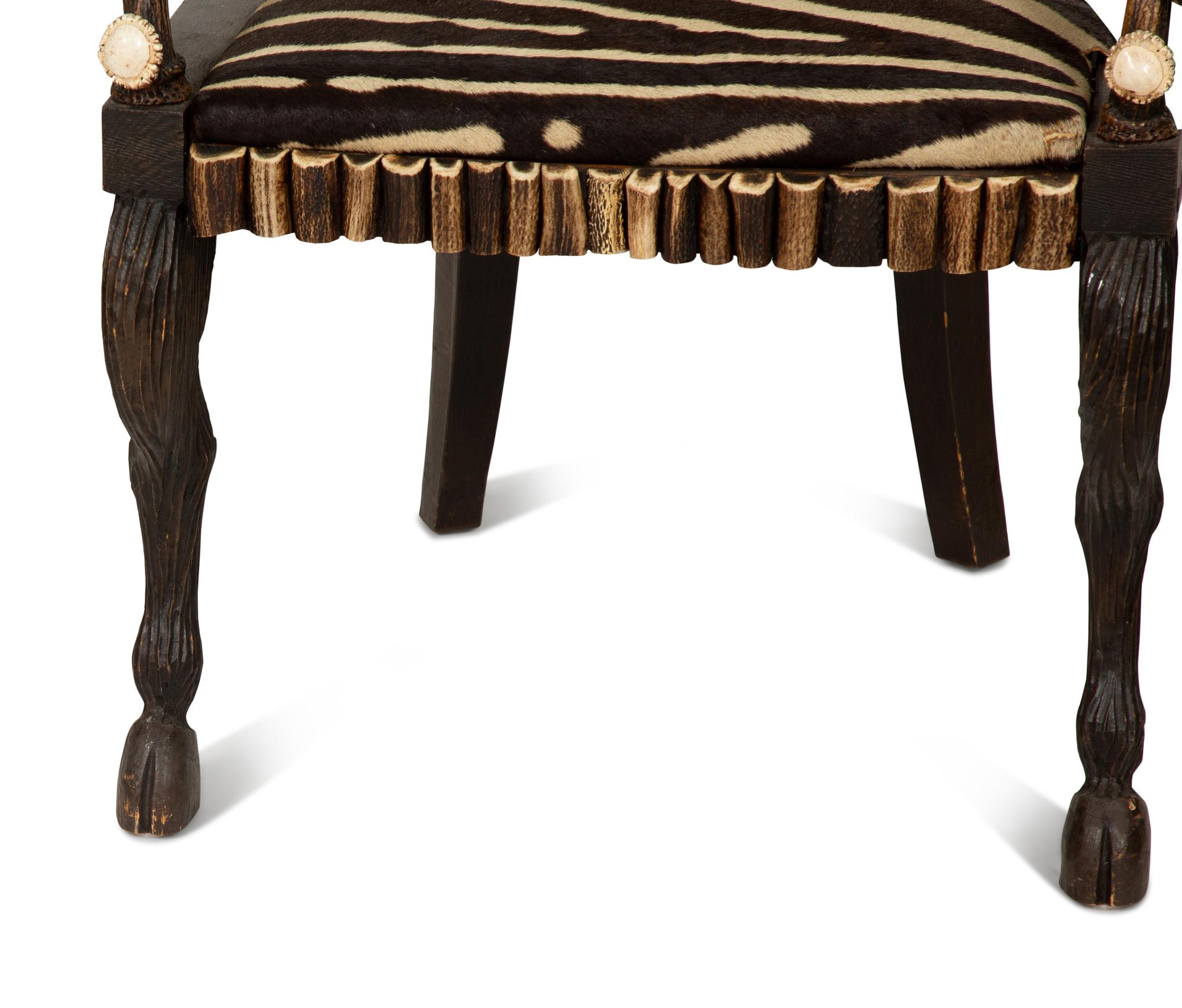 A Pair of Stag Antler Arm Chairs with Zebra Hide Upholstery Attributed to Anthony Redmile
