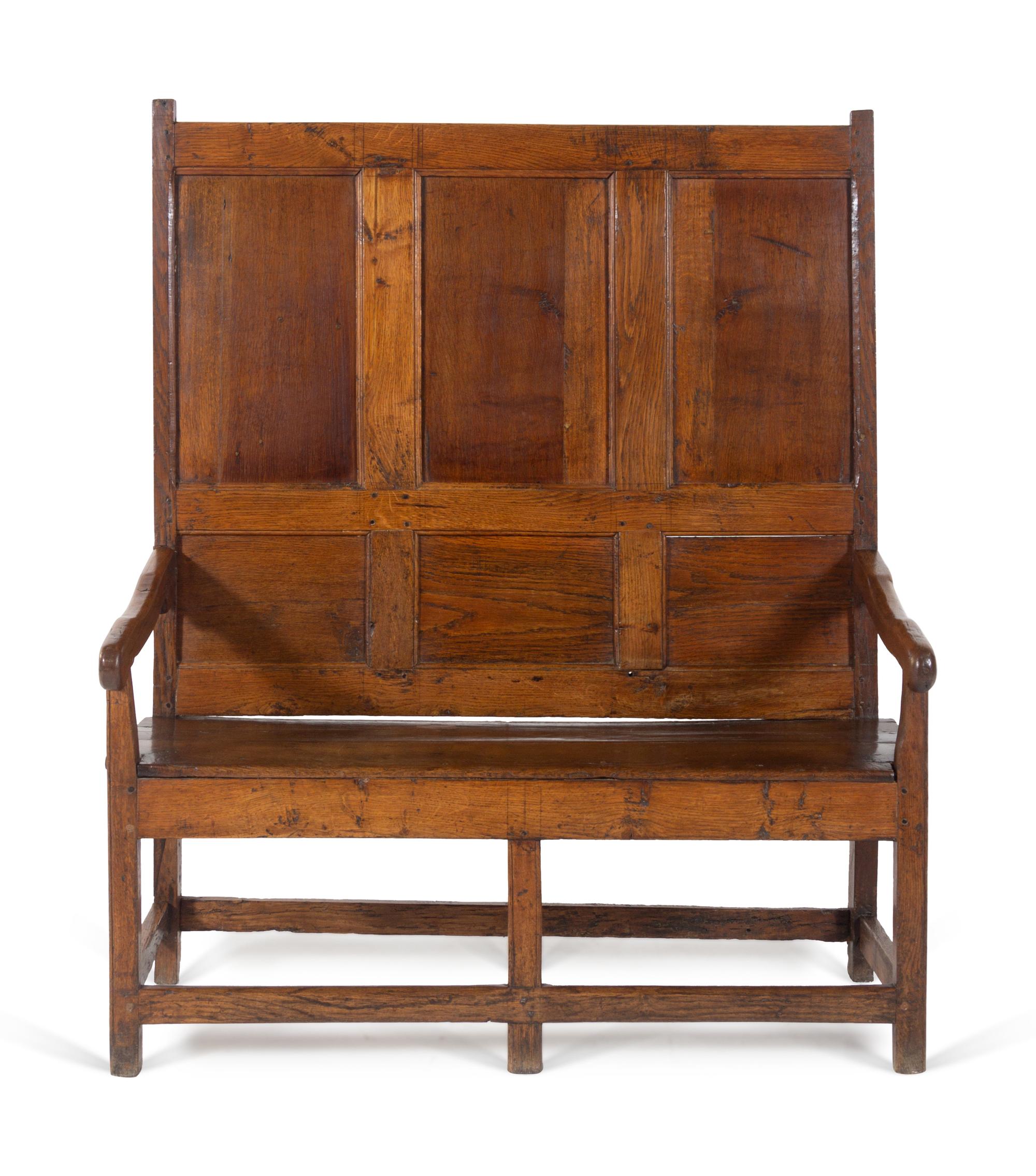 A Jacobean Molded and Paneled Oak Settle