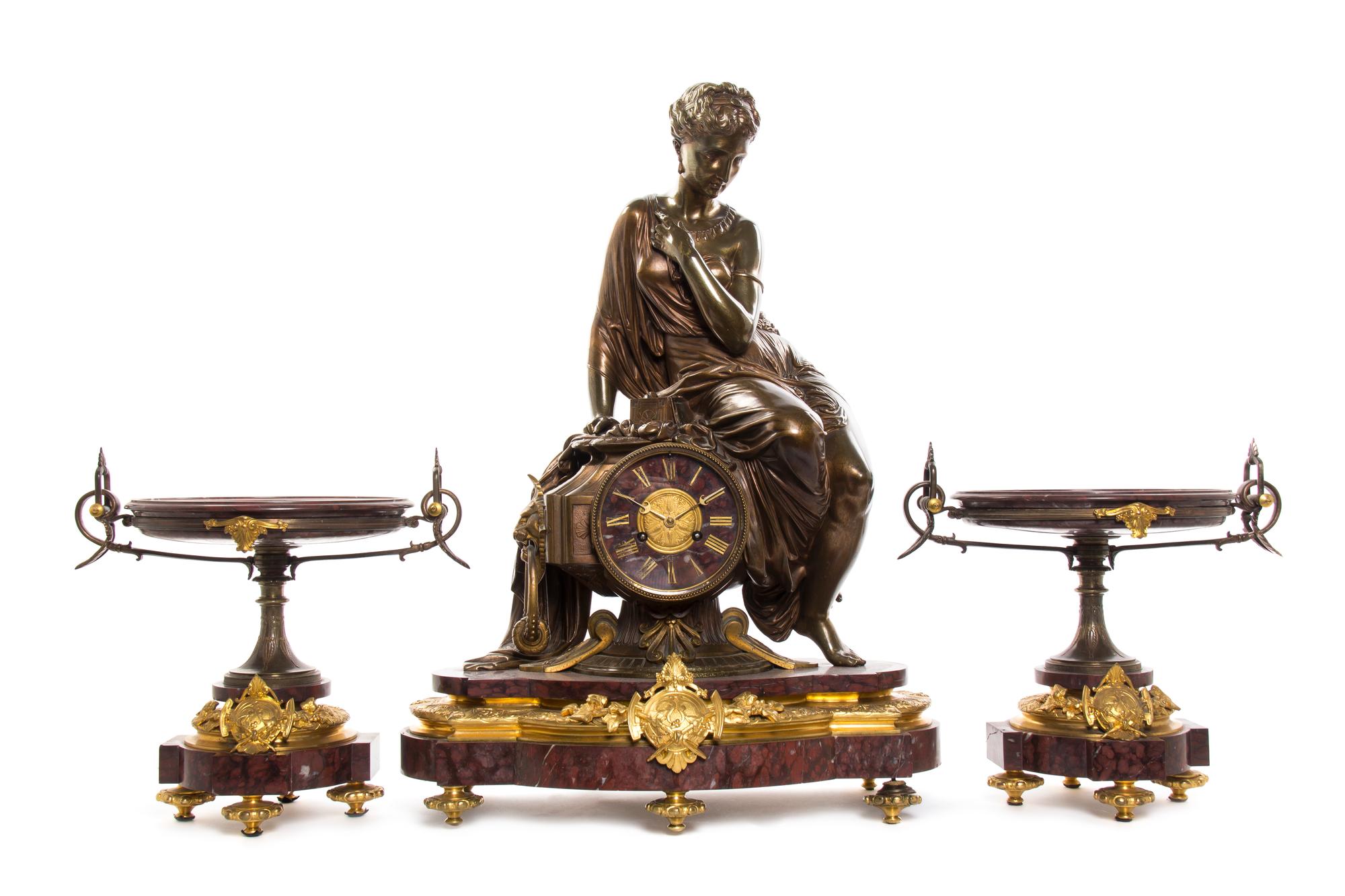 A French Rouge Marble, Gilt and Patinated Bronze Three-Piece Clock Garniture, retailed by H. Pallenberg, Cologne, Height of clock 26 in