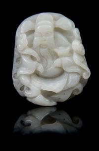 A Carved Jade Toggle Length 2 1/4 inches.