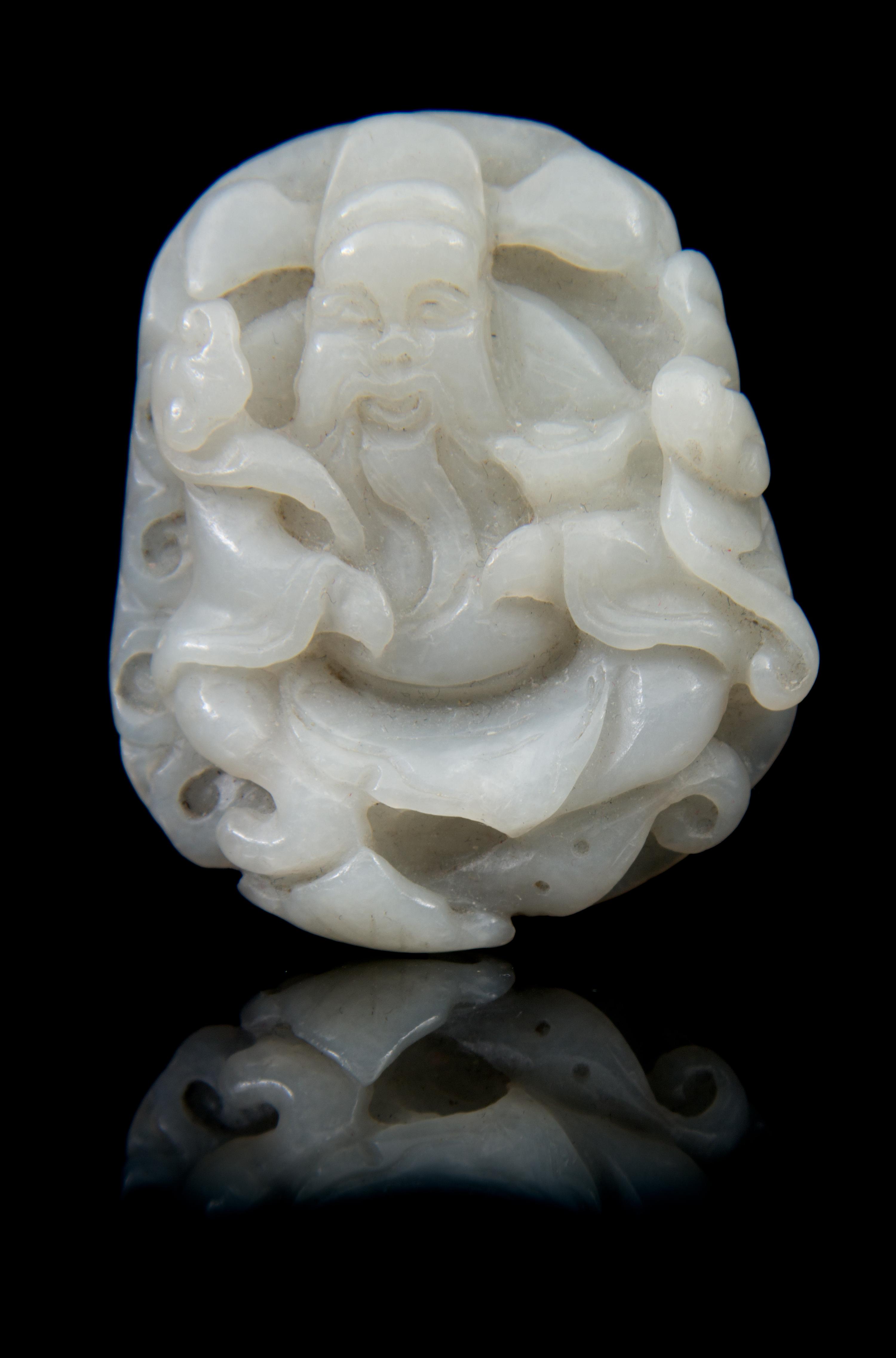 A Carved Jade Toggle Length 2 1/4 inches.