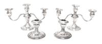Two Pairs of Weighted Sterling Candlesticks, Various Makers, comprising a pair of three-light candlesticks and a pair of single light c
