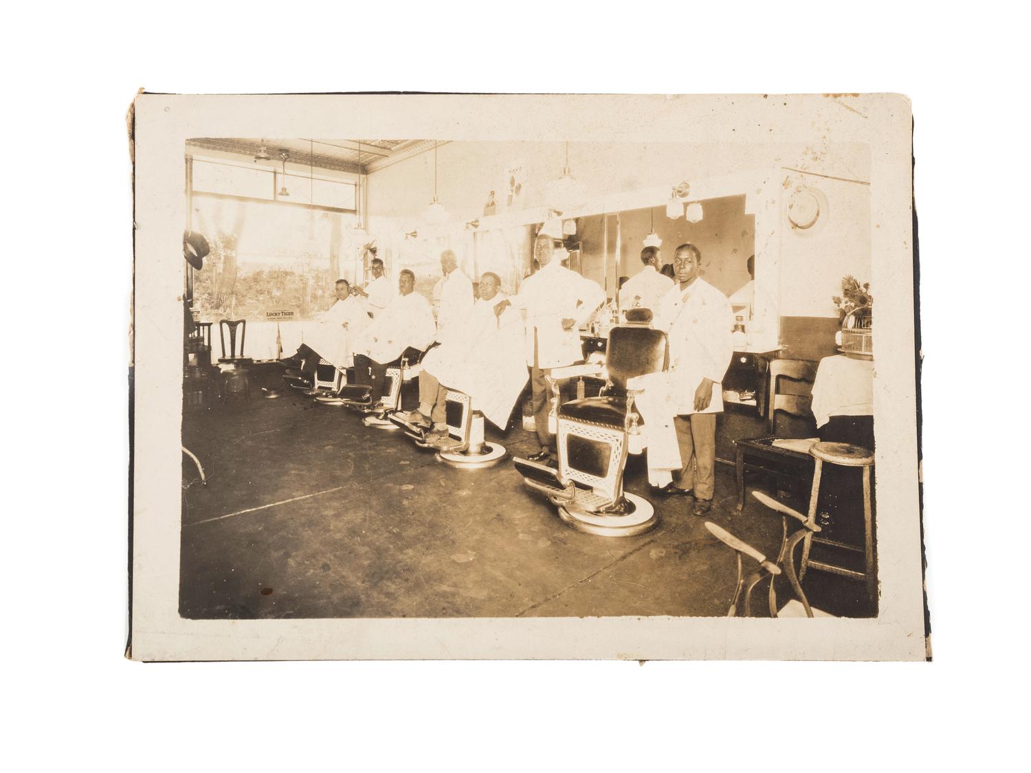 [EARLY PHOTOGRAPHY]. A group of 2 photographs of African American barbershops. Ca early 1900s.