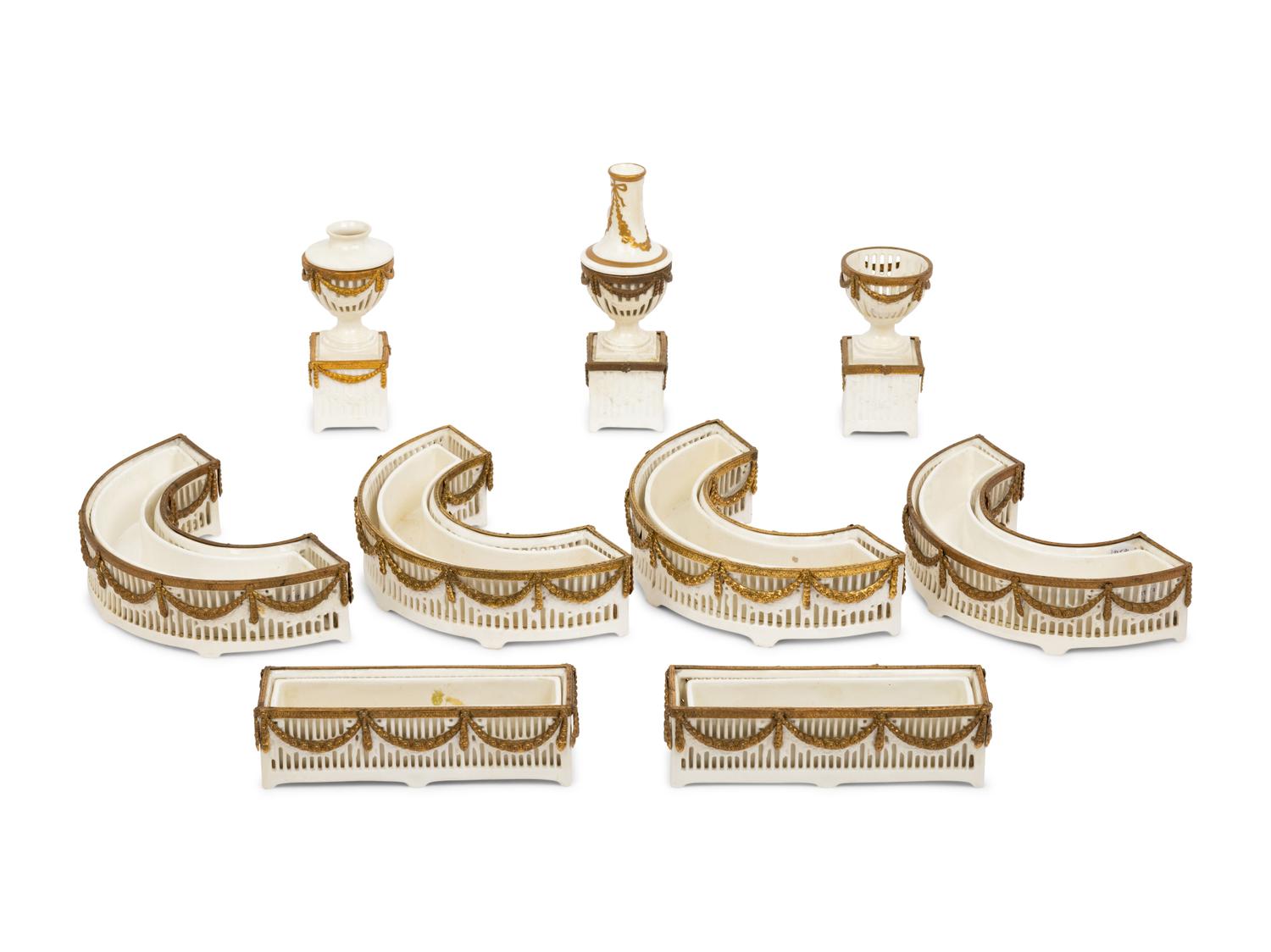A Neoclassical Gilt Metal Mounted Ceramic Table Garniture
