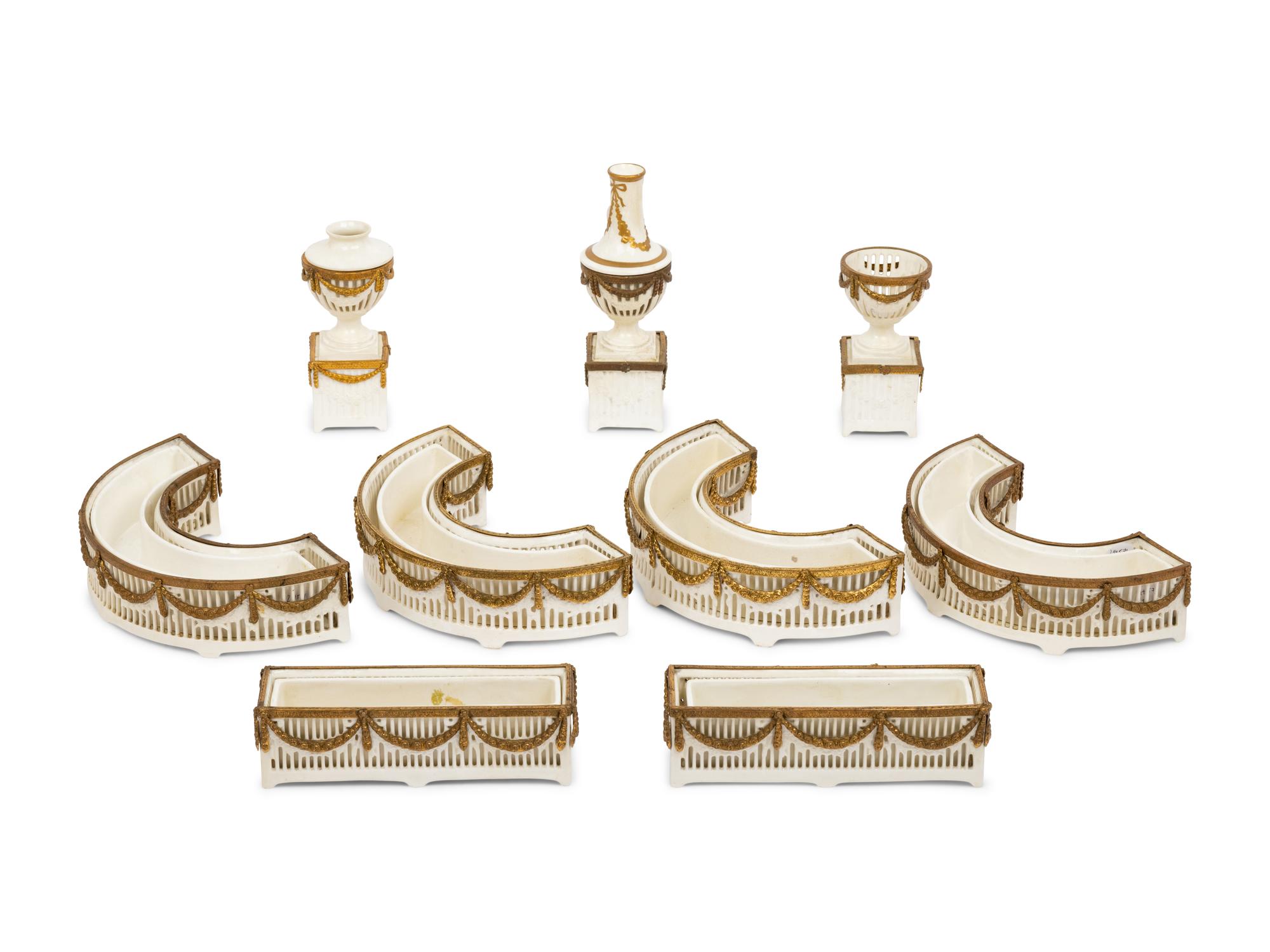 A Neoclassical Gilt Metal Mounted Ceramic Table Garniture