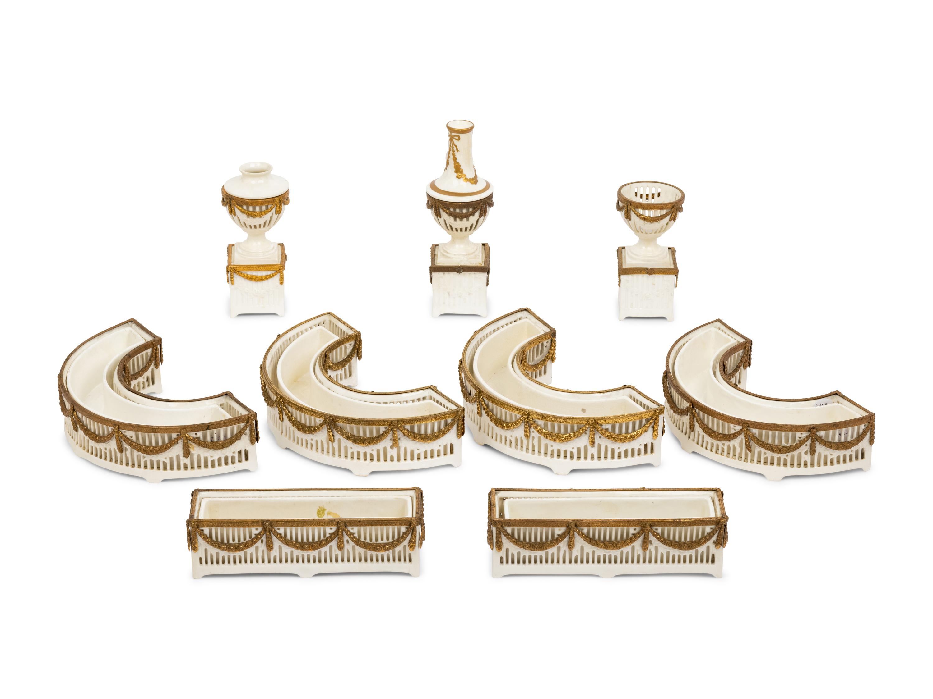 A Neoclassical Gilt Metal Mounted Ceramic Table Garniture