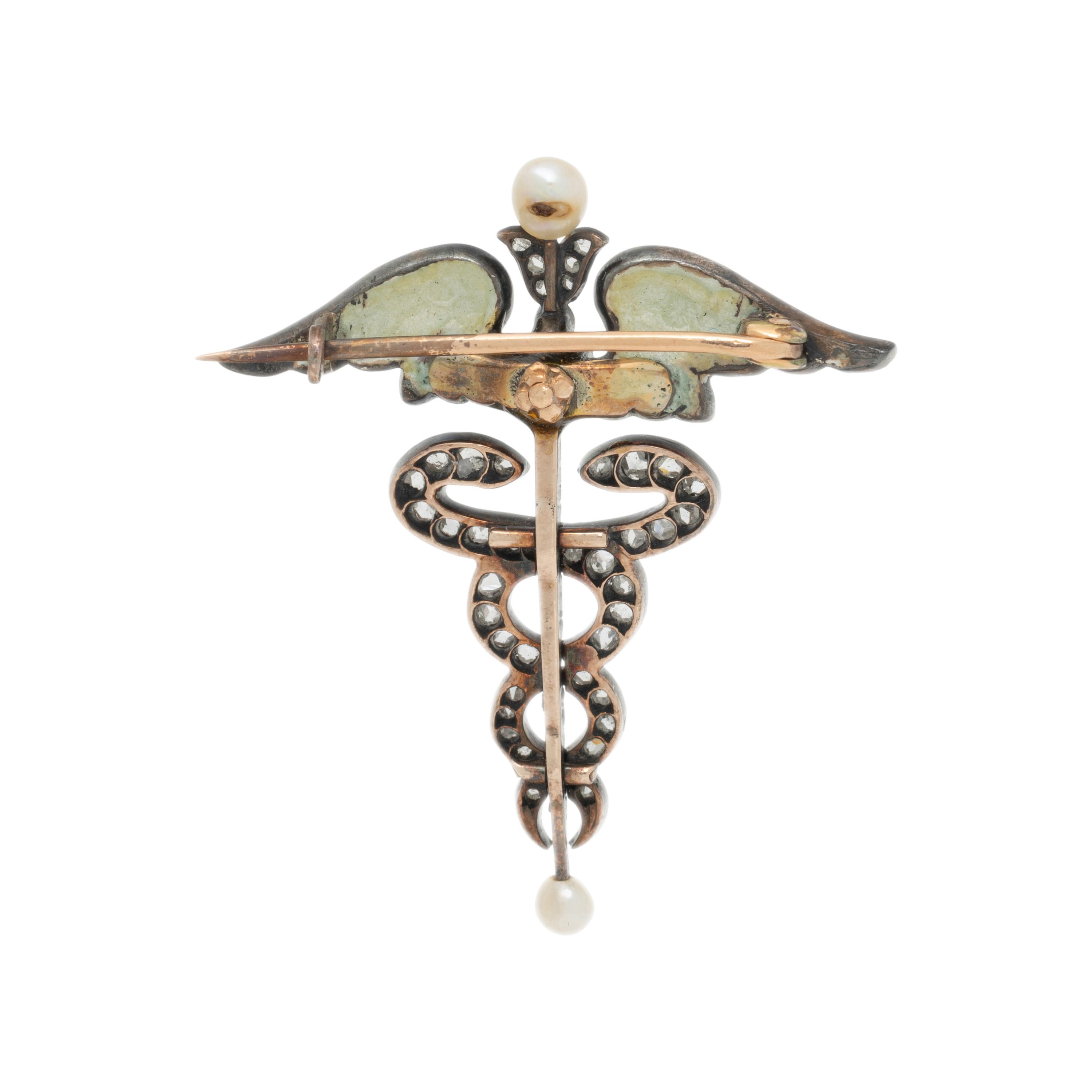 ART NOUVEAU, DIAMOND, SEED PEARL, DEMANTOID GARNET, AND ENAMEL CADUCEUS BROOCH