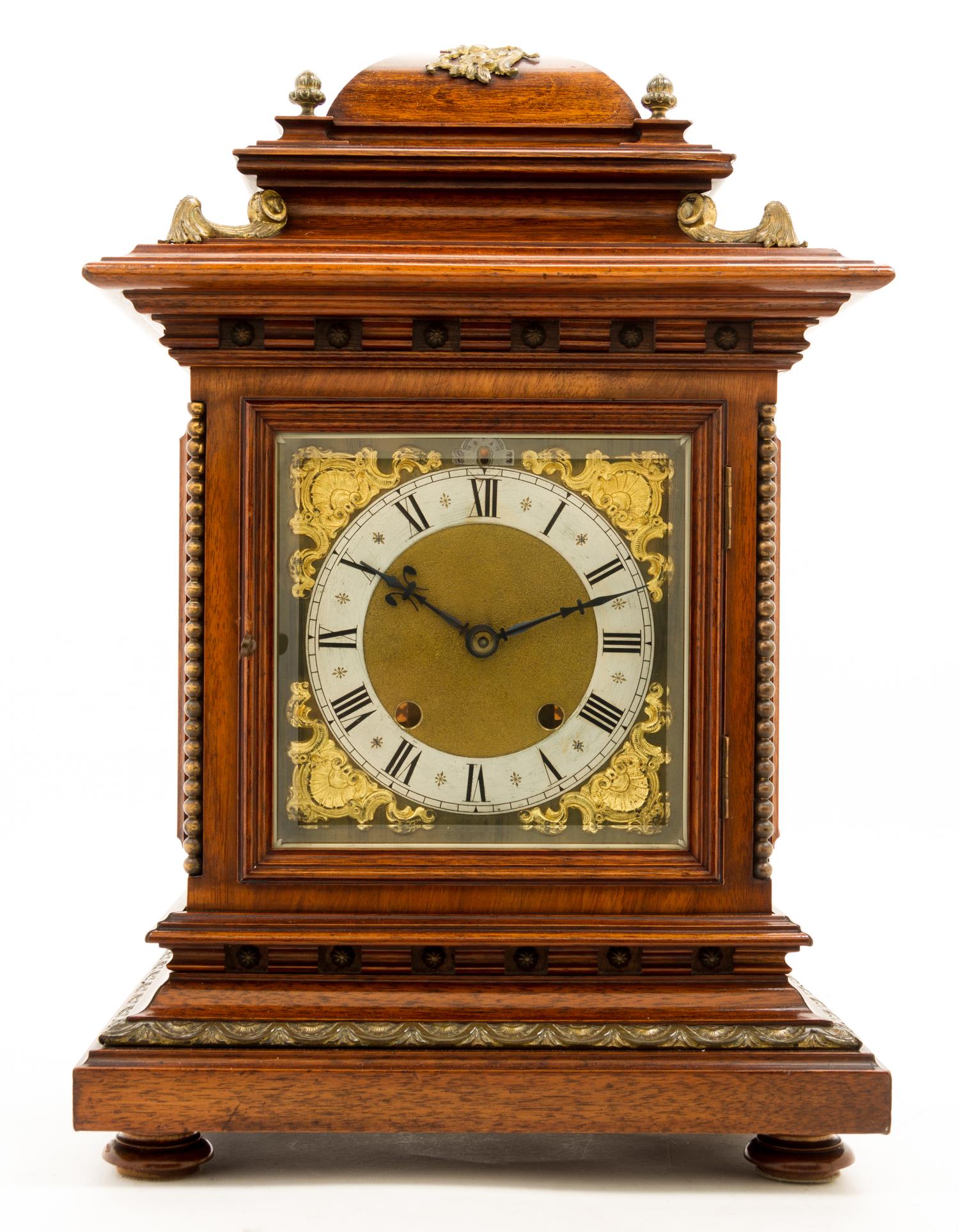 A Walnut and Brass Mantel Clock Height 18 inches.