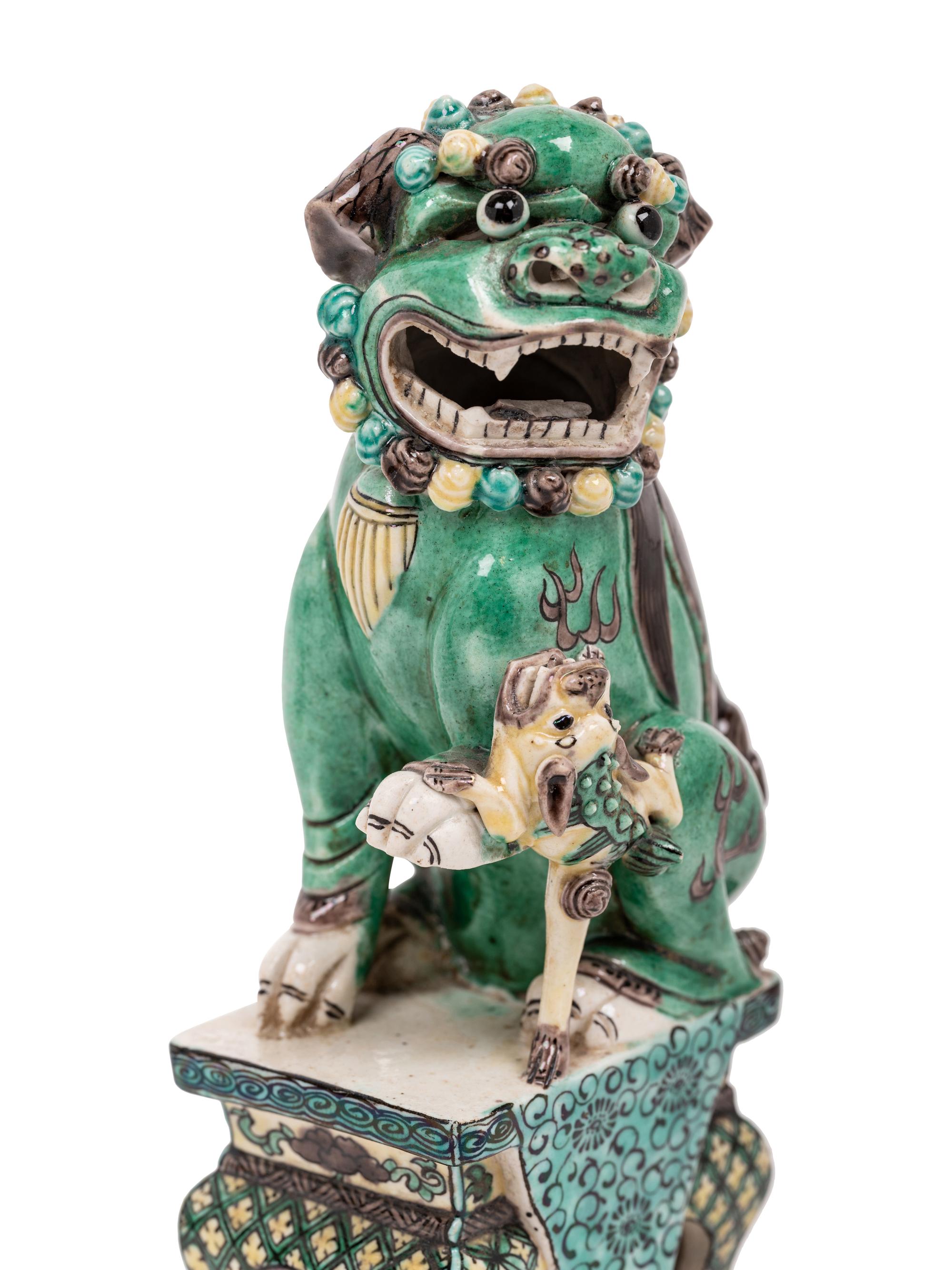 A Pair of Chinese Famille Verte Porcelain Figures of Fu Lions
