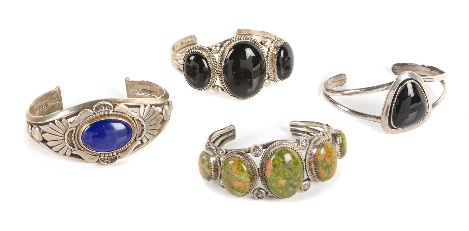 Four Southwestern Cuff Bracelets Length of largest 5 3/4 x opening 1 1/4 x width 1 1/4 inches