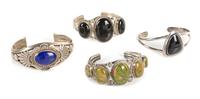 Four Southwestern Cuff Bracelets Length of largest 5 3/4 x opening 1 1/4 x width 1 1/4 inches