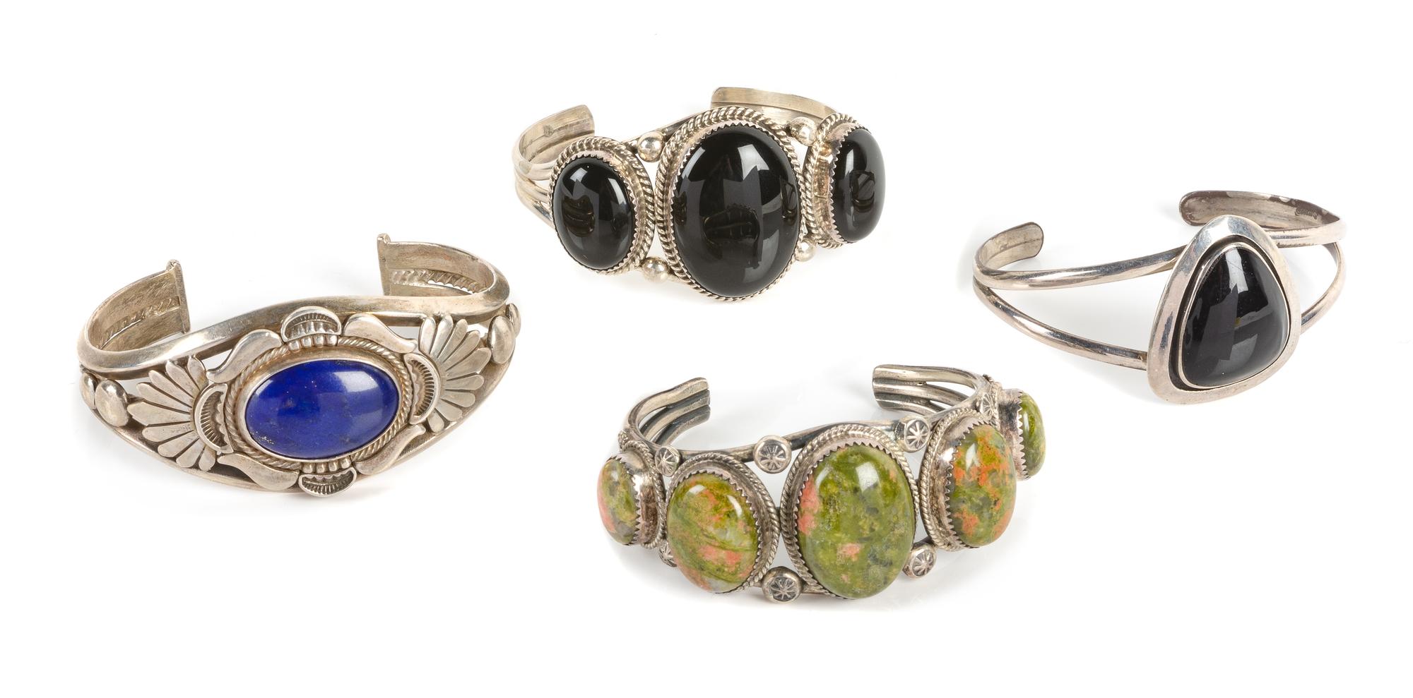 Four Southwestern Cuff Bracelets Length of largest 5 3/4 x opening 1 1/4 x width 1 1/4 inches