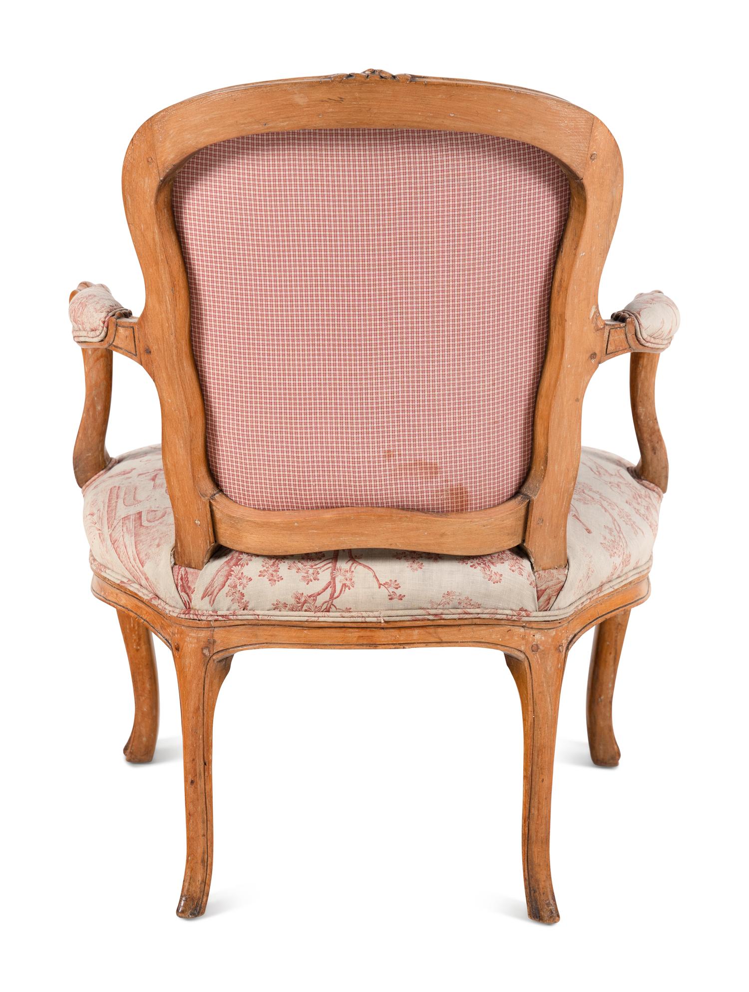 A Louis XV Carved Fruitwood Fauteuil