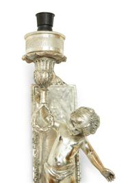 A Pair of Continental Silvered Metal Figural Wall Lights