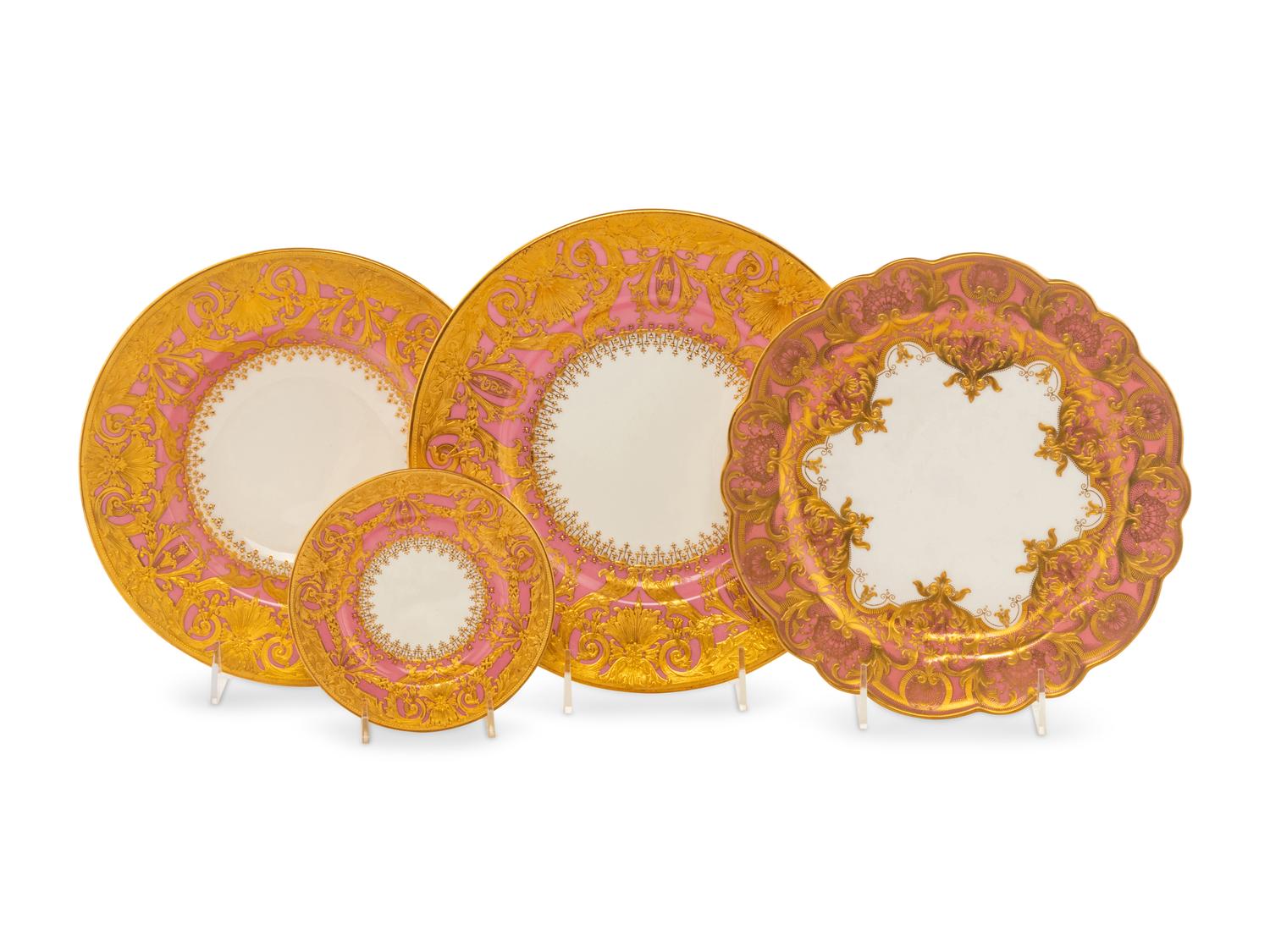 A Minton Parcel Gilt Porcelain Dinner Service by S.J. Russell