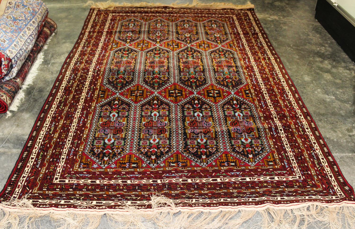 A Group of Four Wool Rugs Dimensions of largest 9 feet 7 inches x 6 feet 4 inches.