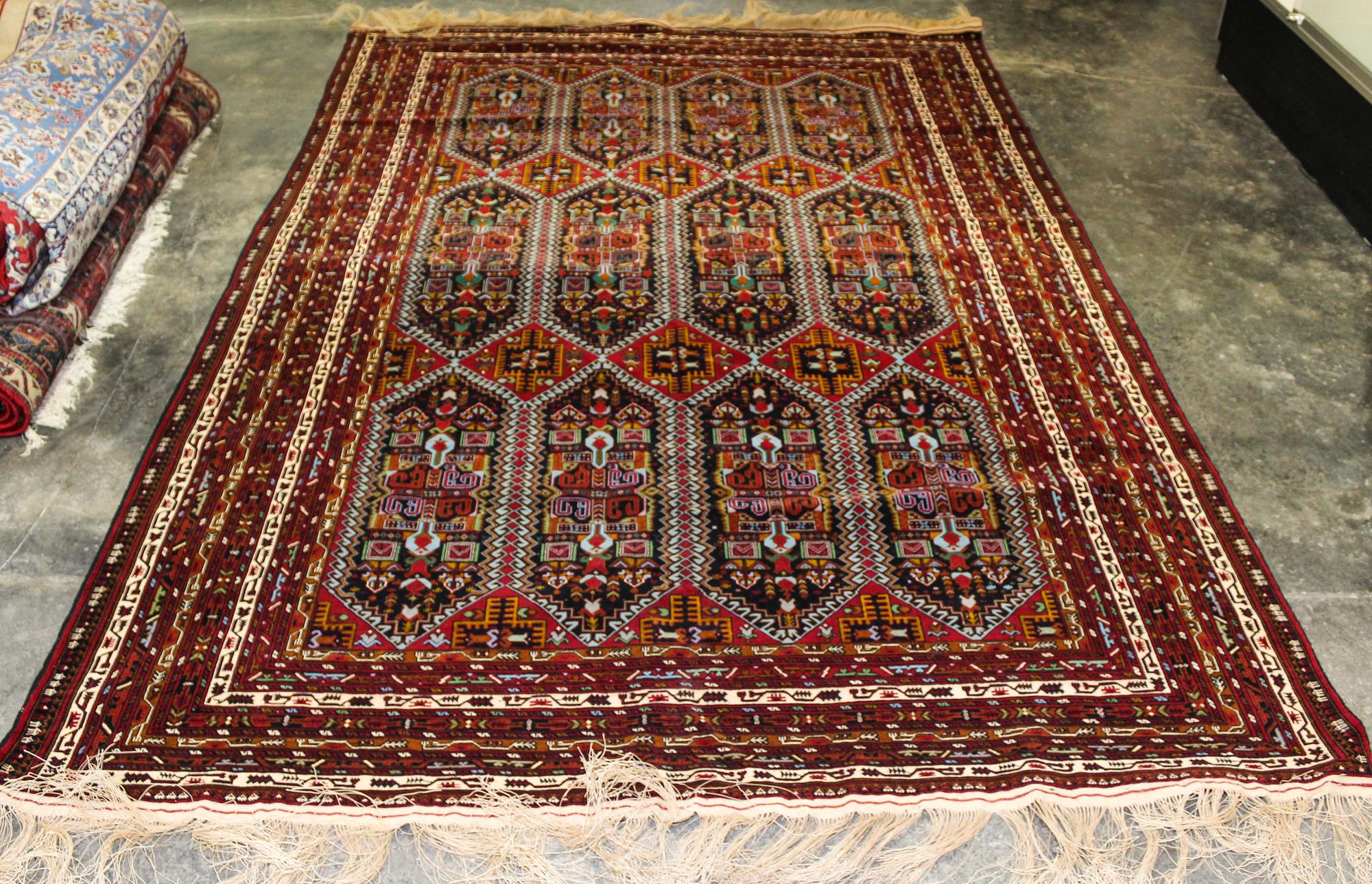 A Group of Four Wool Rugs Dimensions of largest 9 feet 7 inches x 6 feet 4 inches.