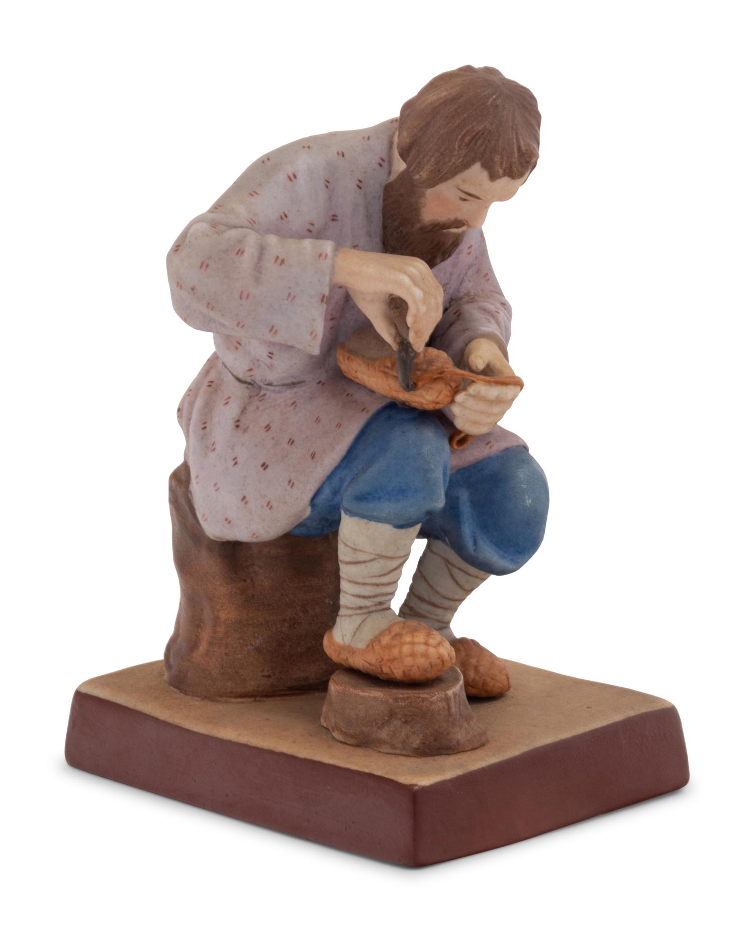 A Russian Porcelain Figure of a Bast Shoe Maker