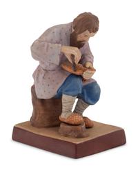 A Russian Porcelain Figure of a Bast Shoe Maker