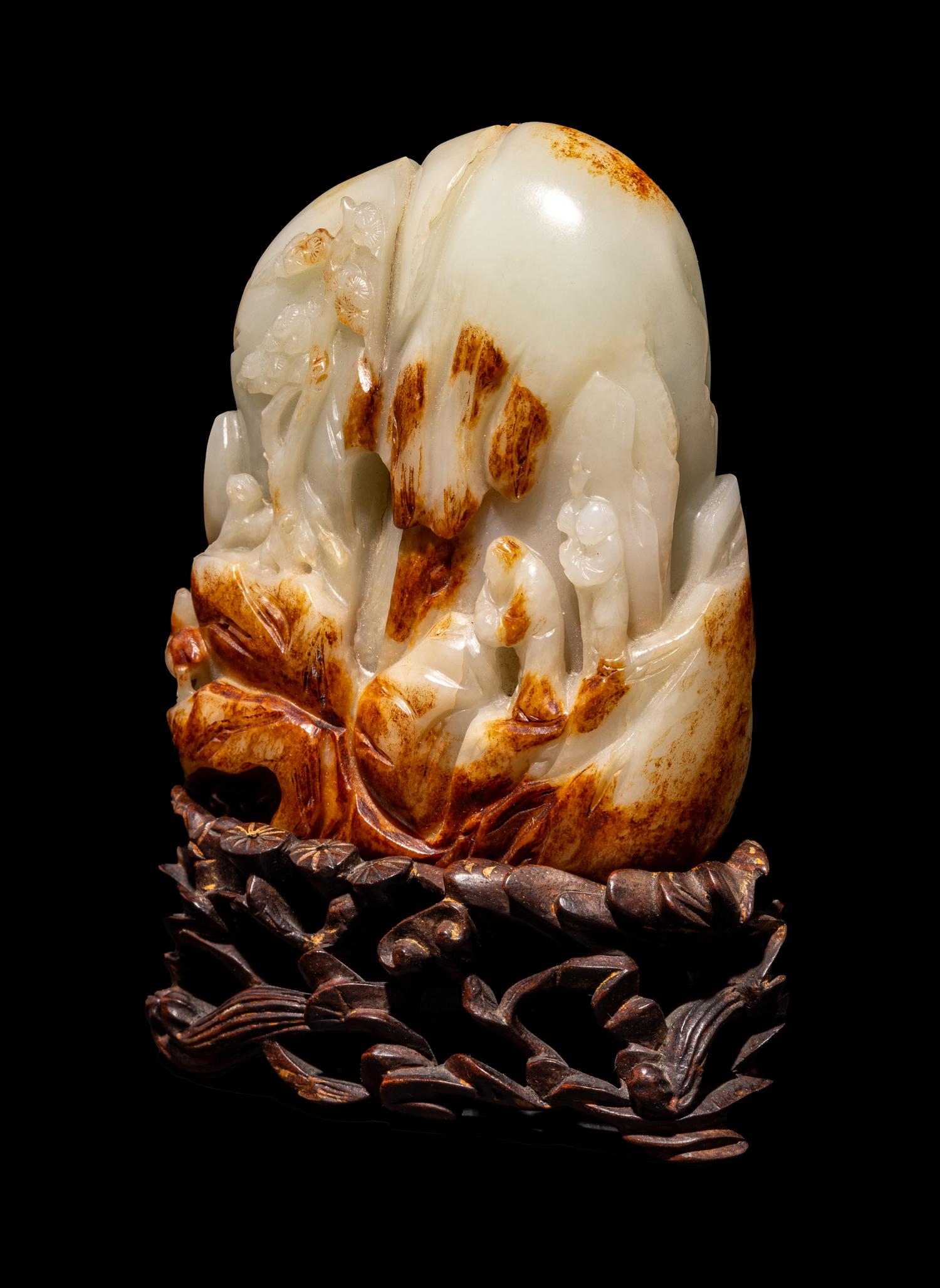 A Chinese Celadon and Russet Jade 'Landscape' Boulder
