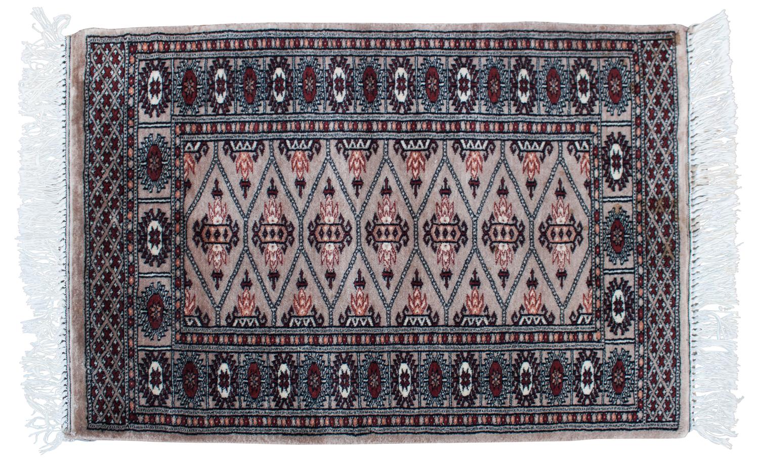 An Oriental Wool Rug 3 feet 1 inch x 2 feet 1 inch.