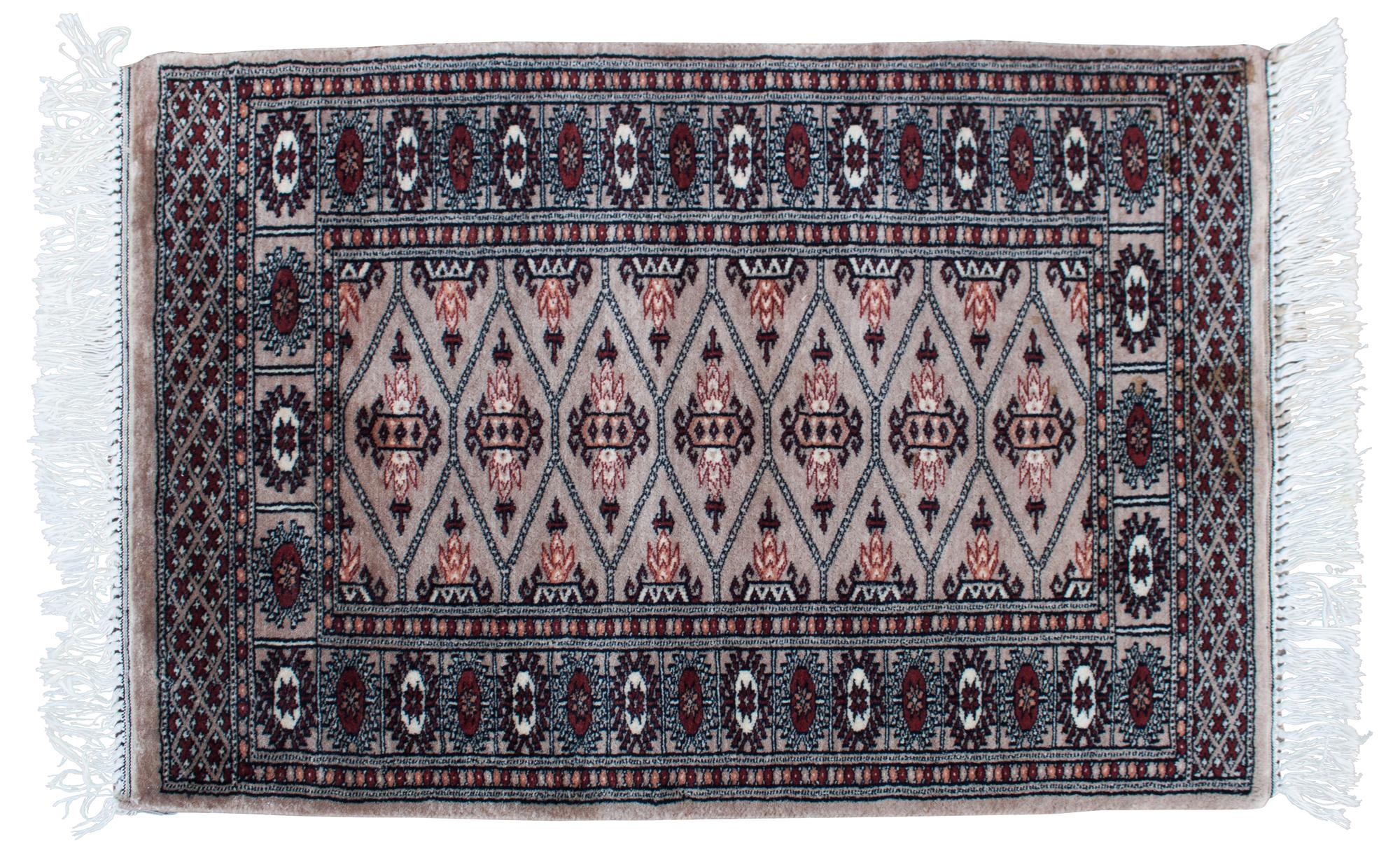 An Oriental Wool Rug 3 feet 1 inch x 2 feet 1 inch.