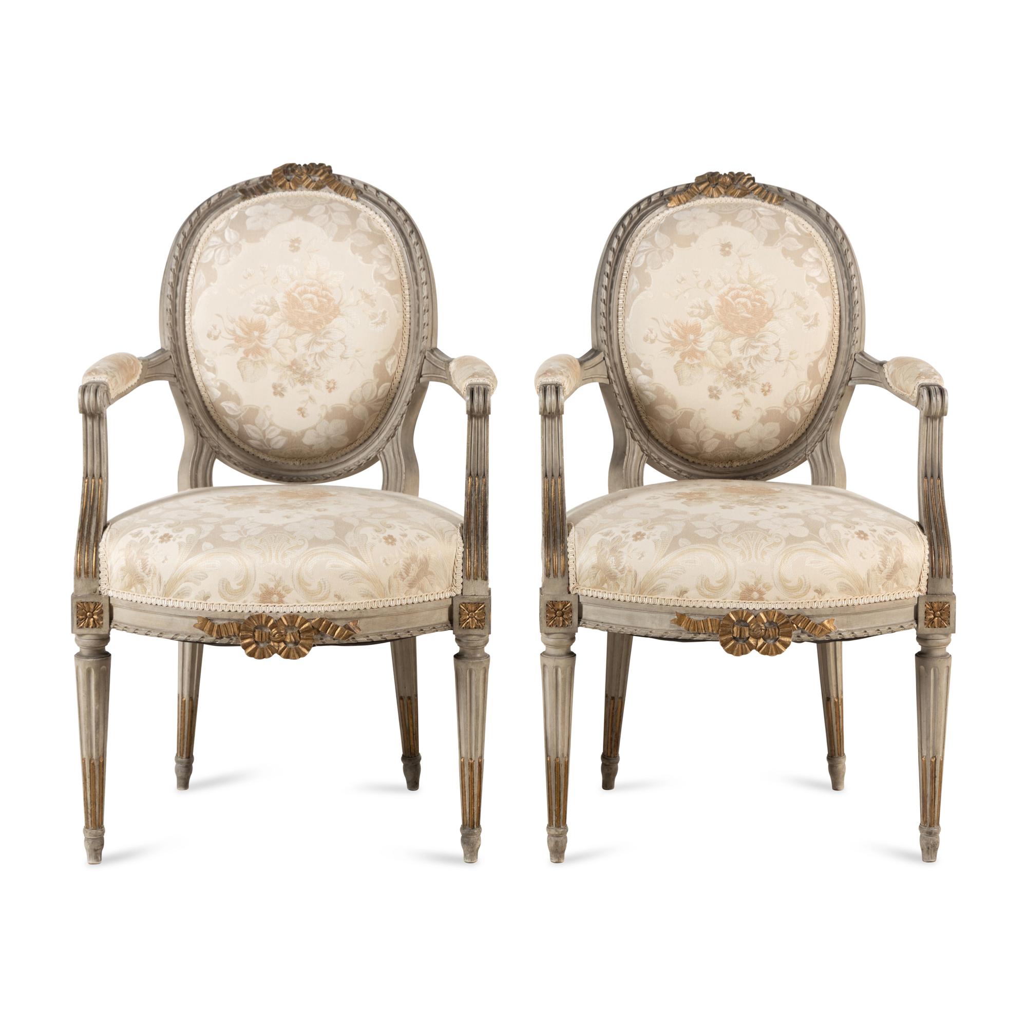 A Pair of Louis XVI Style Gray-Painted and Parcel-Gilt Armchairs