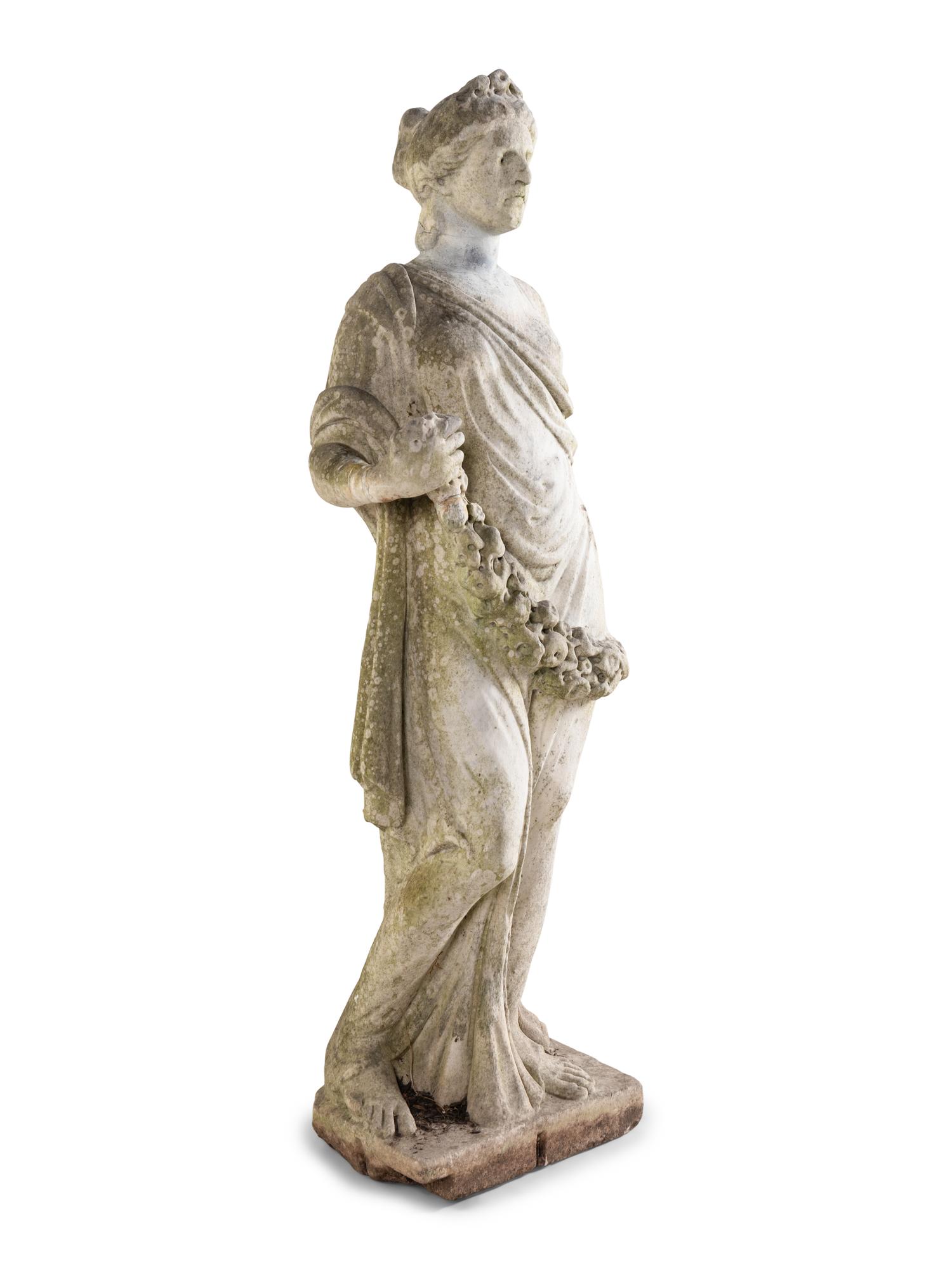 A Carved Marble Figure of a Maiden with Garlands