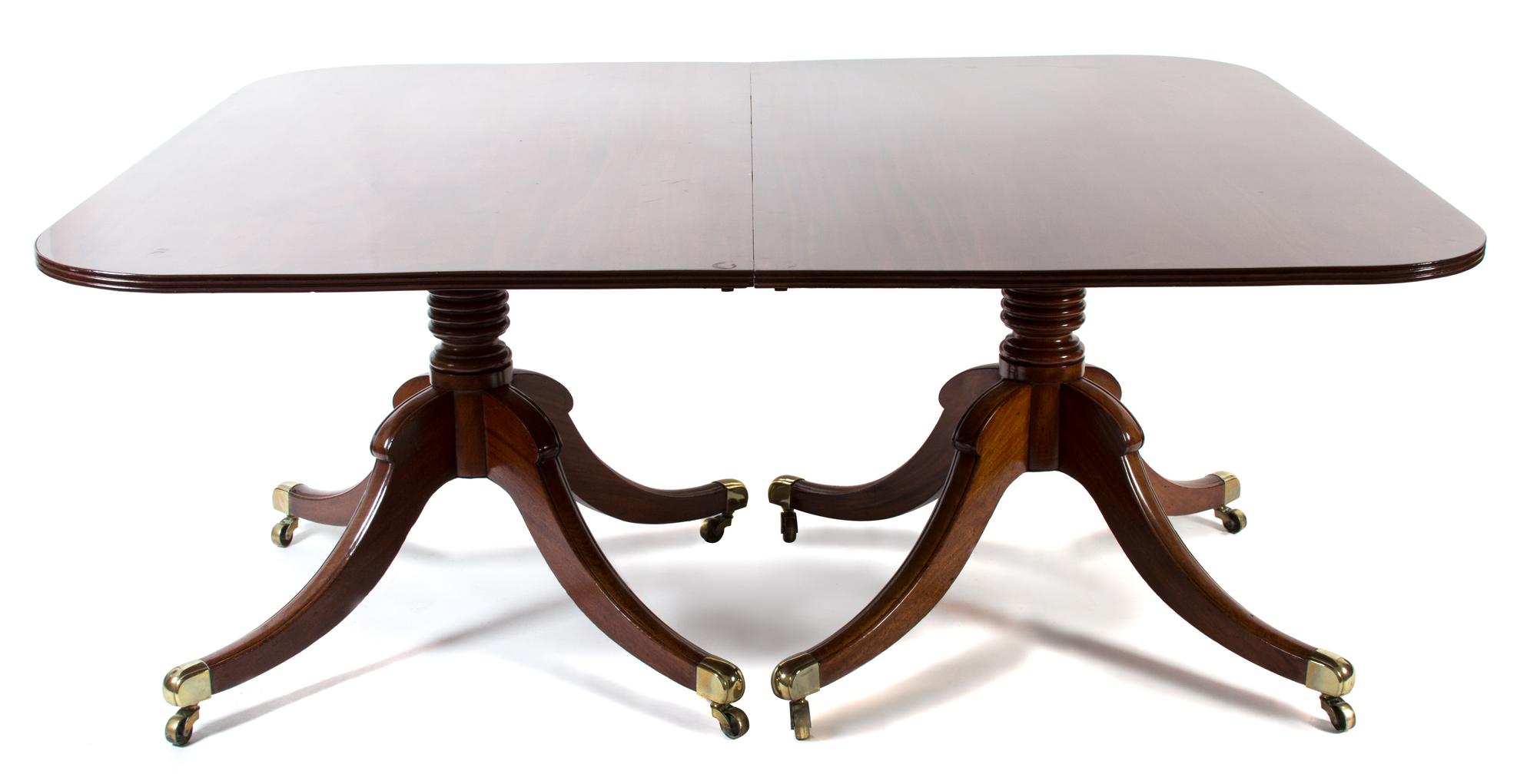 A George III Style Mahogany Two-Pedestal Dining Table Height 29 x length with leaves 104 x depth 55 1/2 inches. — 19TH CENTURY