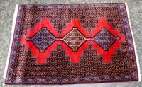 A Small Persian Rug with Medallion Design 3 feet 4 inches x 2 feet 5 1/2 inches.