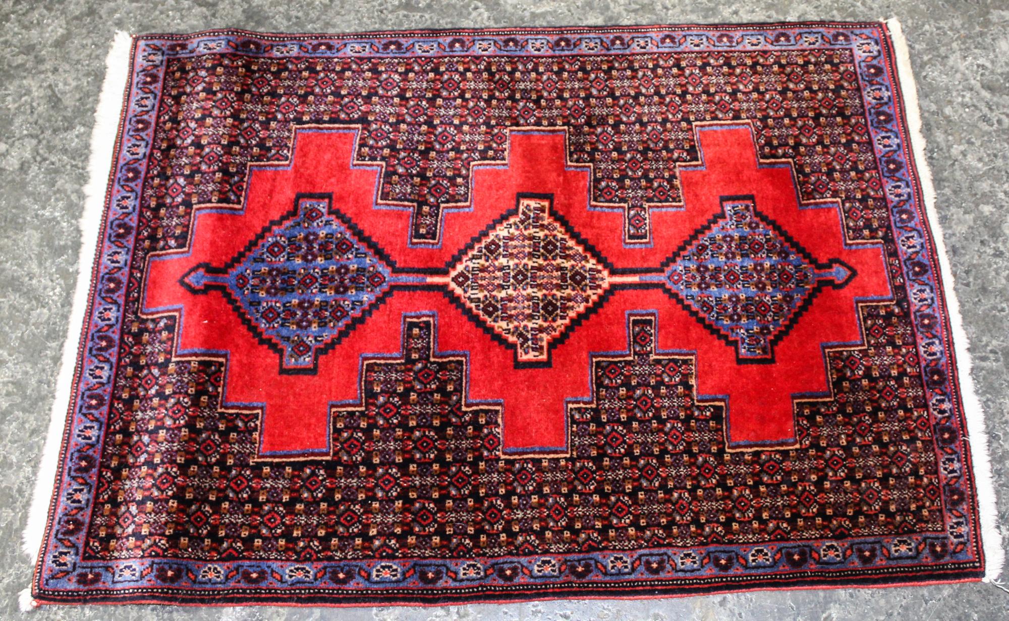 A Small Persian Rug with Medallion Design 3 feet 4 inches x 2 feet 5 1/2 inches.