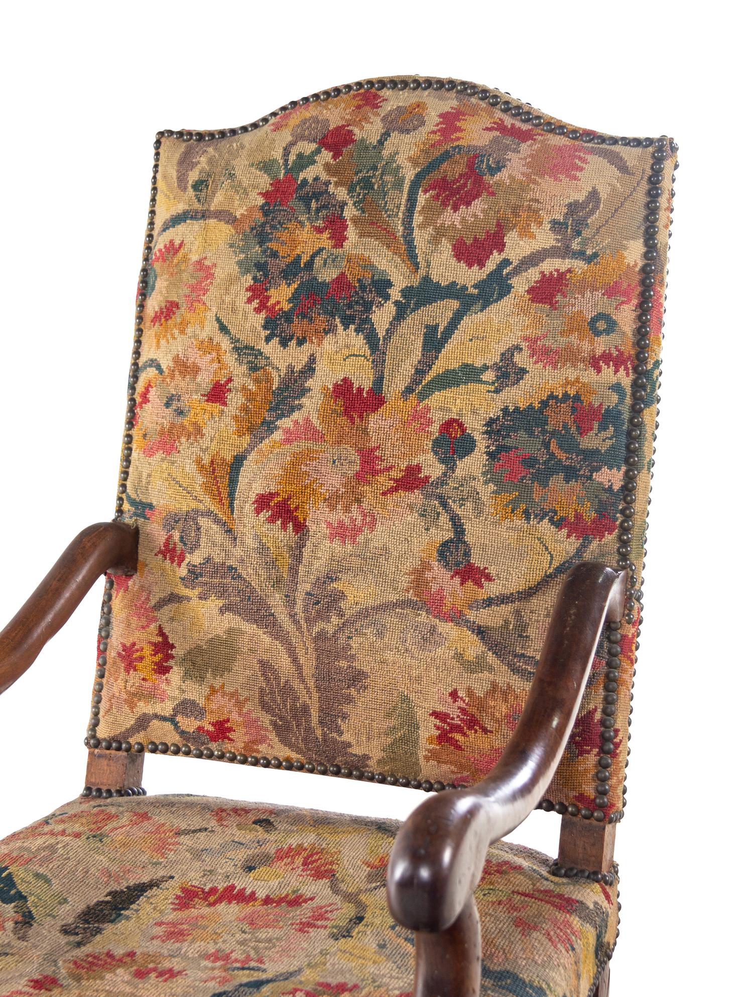 A Louis XIV Walnut Fauteuil à la Reine with Needlework Upholstery