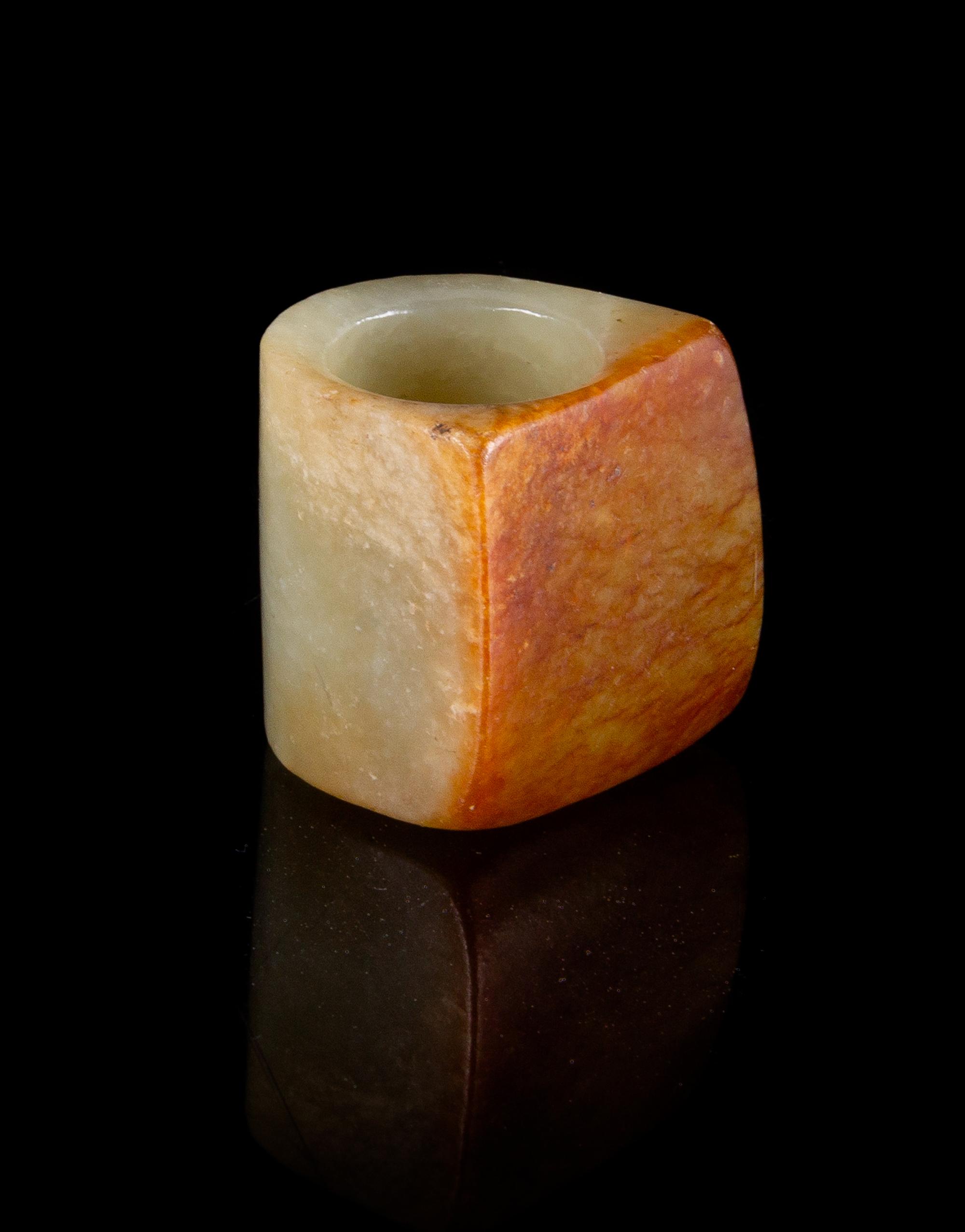 A Celadon and Russet Jade Archer's Ring Length 1 1/8 inches. — QING DYNASTY (1644-1911)