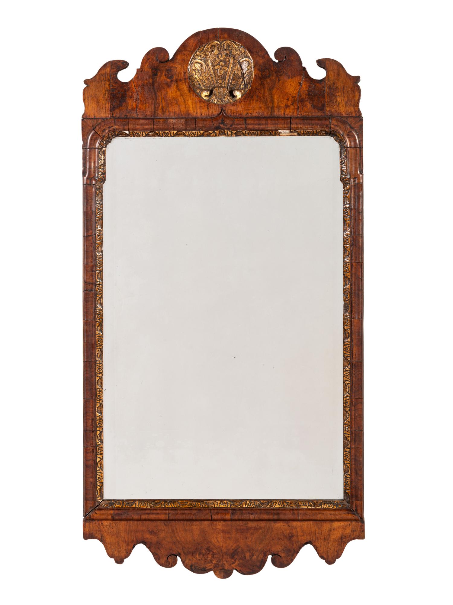 A Queen Anne Walnut and Giltwood Mirror