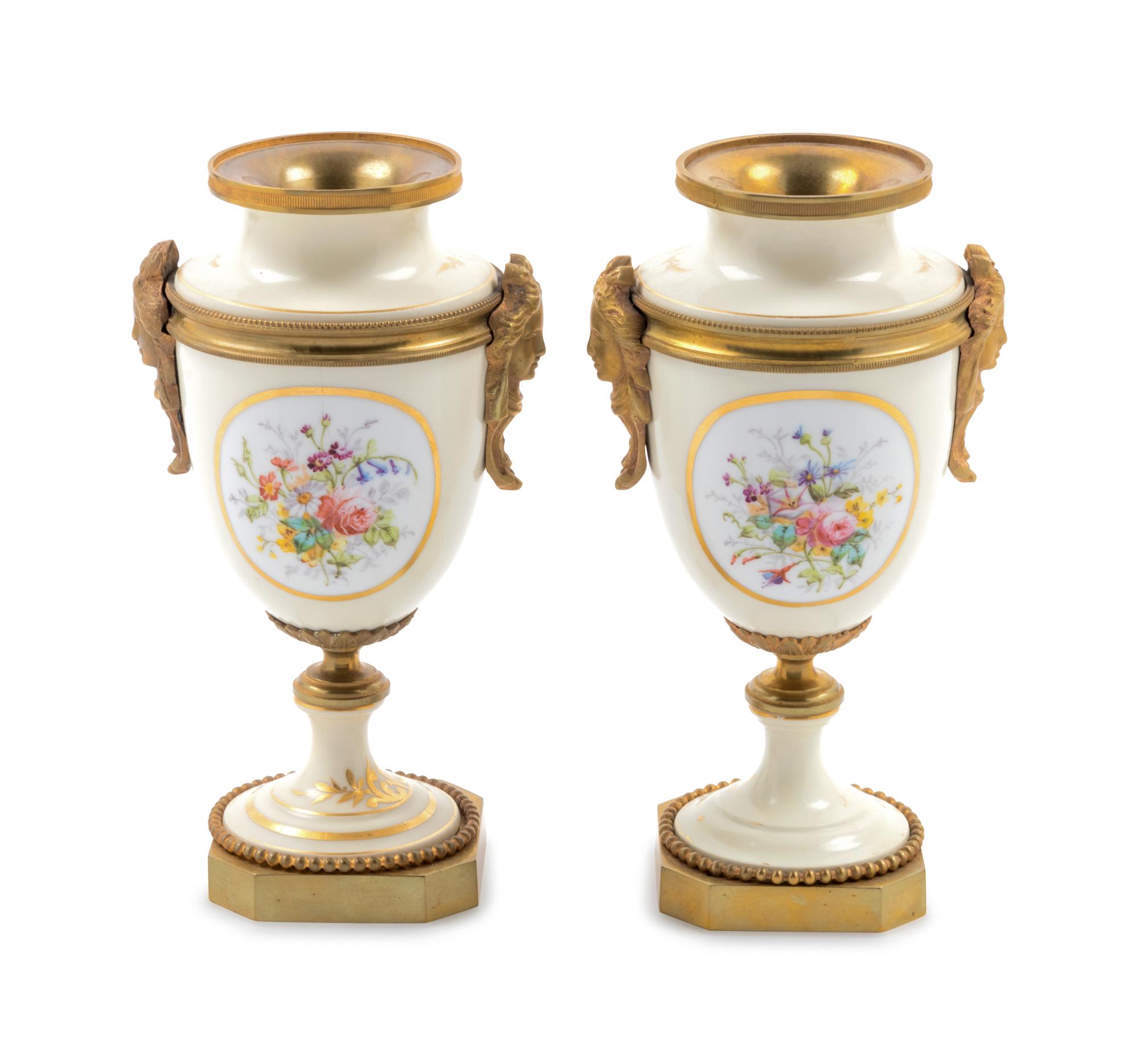A Pair of Sèvres Style Gilt Bronze Mounted Painted and Parcel Gilt Porcelain Urns