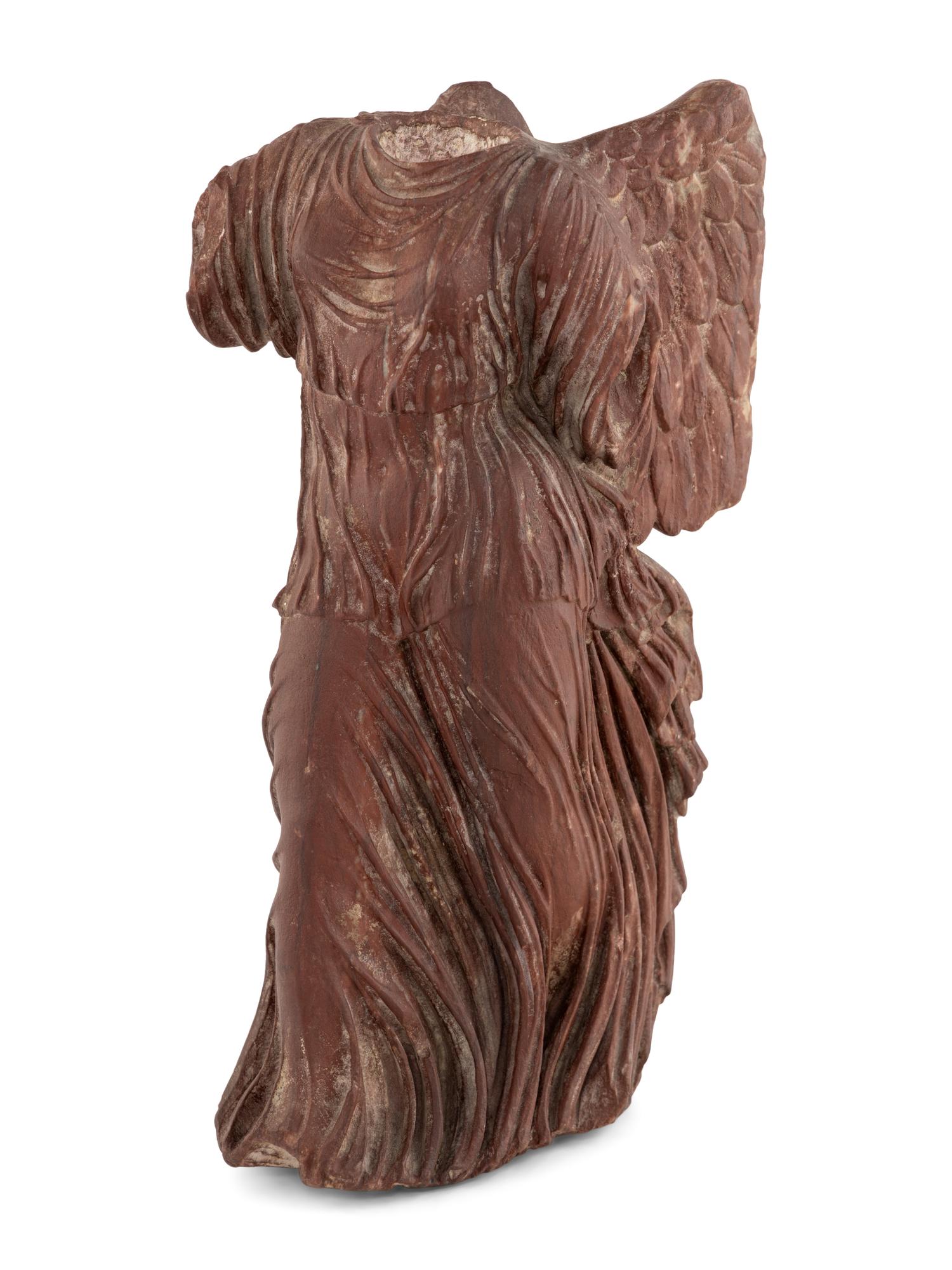 A Carved Red Marble Figure of the Nike of Samothrace