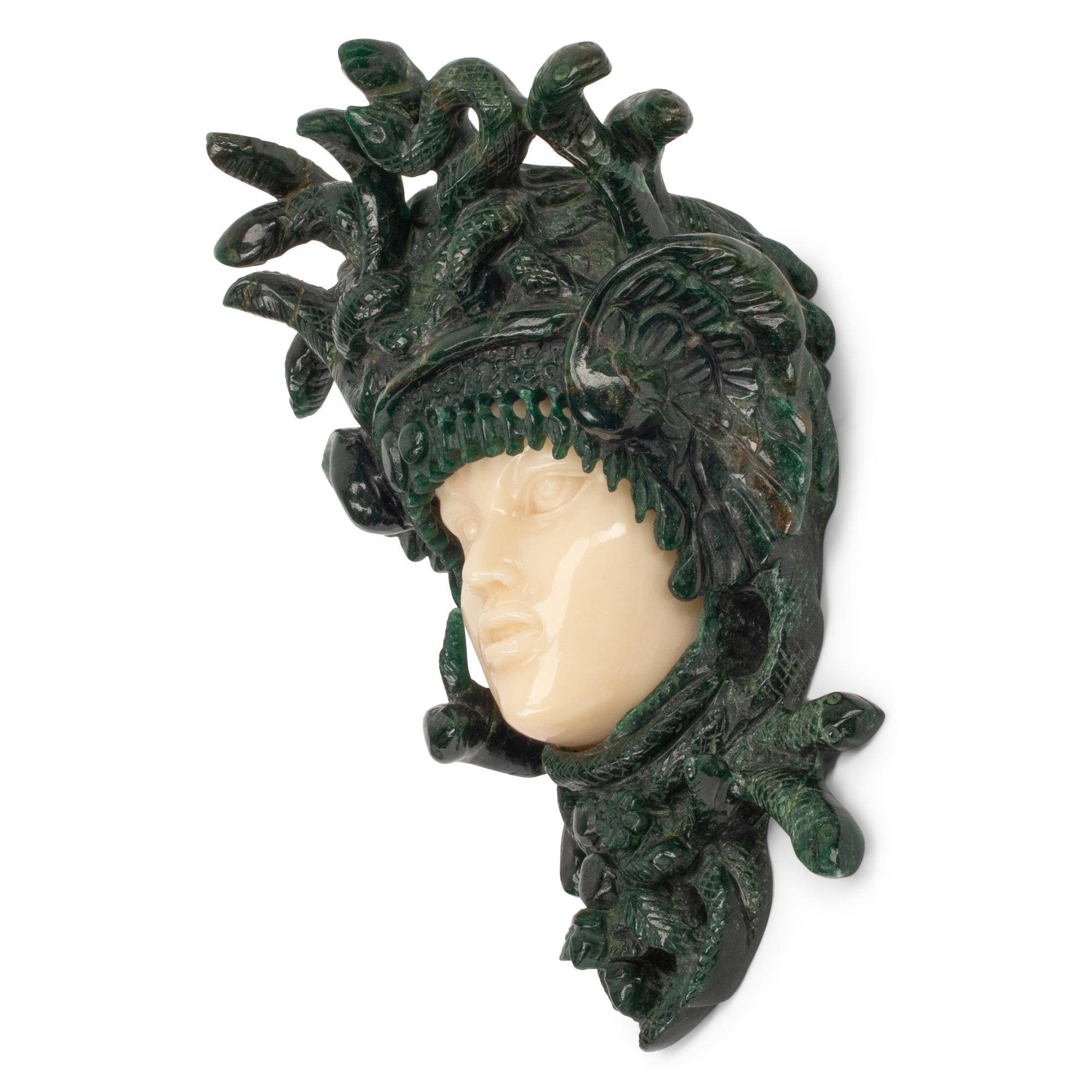A Carved Green and Yellow Aventurine Medusa Wall Ornament