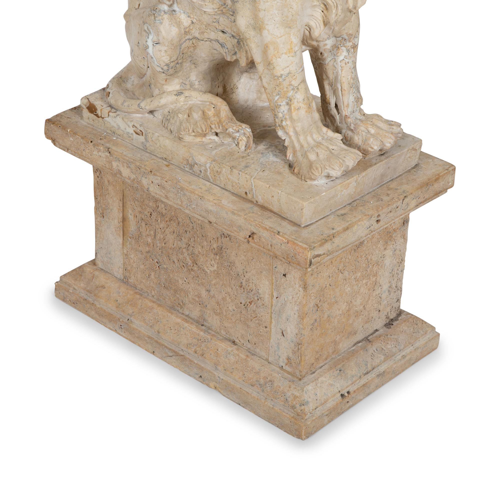 A Carved Marble Winged Seated Lion on Pedestal Base