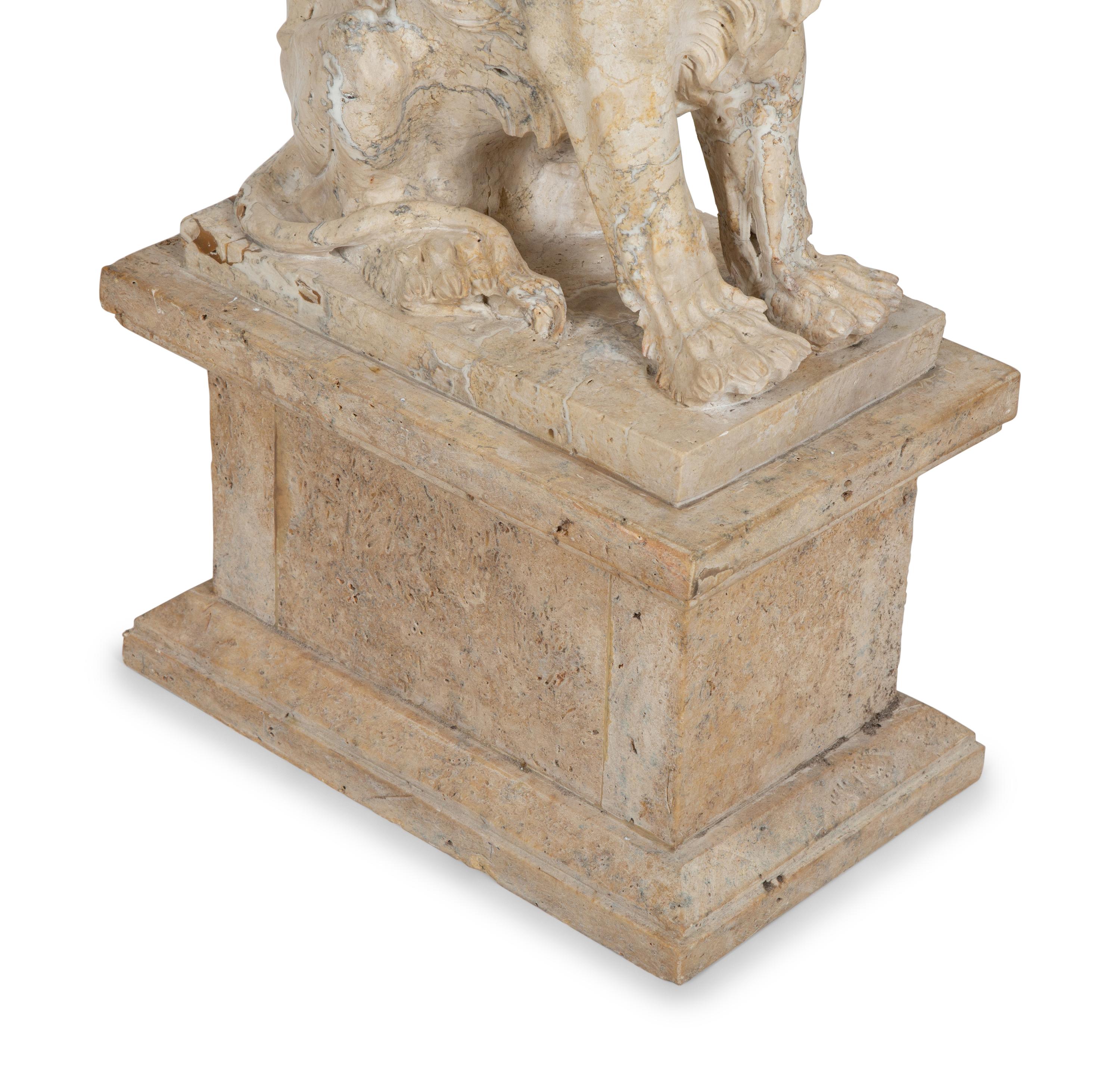 A Carved Marble Winged Seated Lion on Pedestal Base