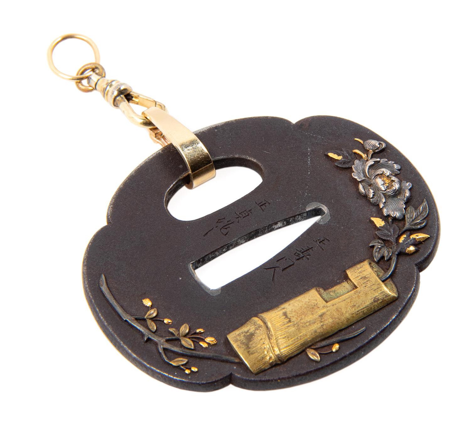 A Japanese Tsuba Length 2 1/2 x width 2 1/4 inches.