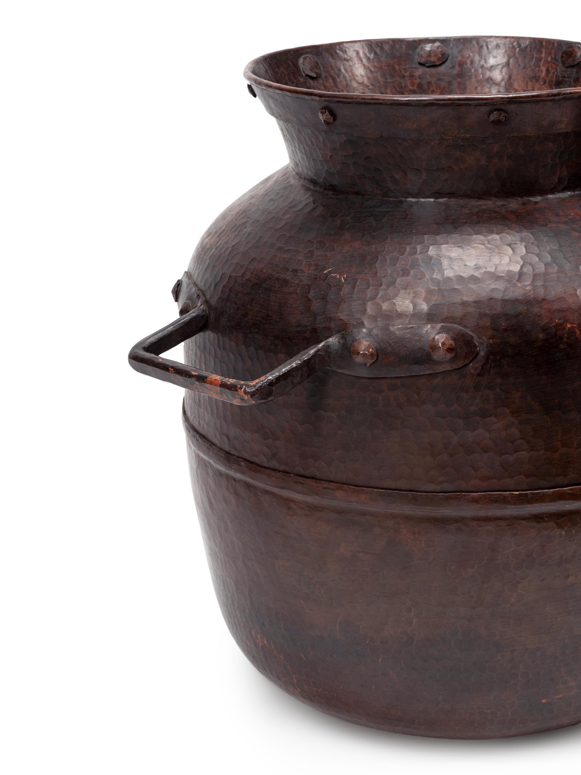 A Pair of Large Iron Mounted Hammered Metal Jars