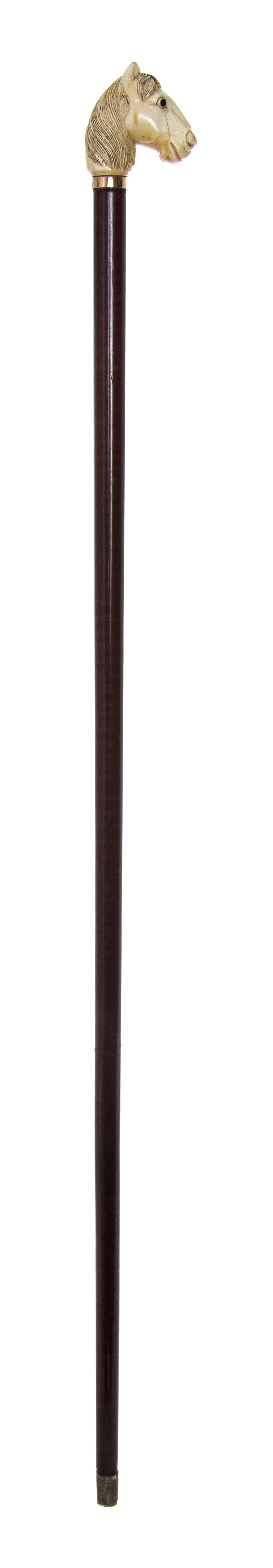 An Ivory Carved Handled Cane, Length of handle 2 1/4 x length overall 34 1/2 inches.