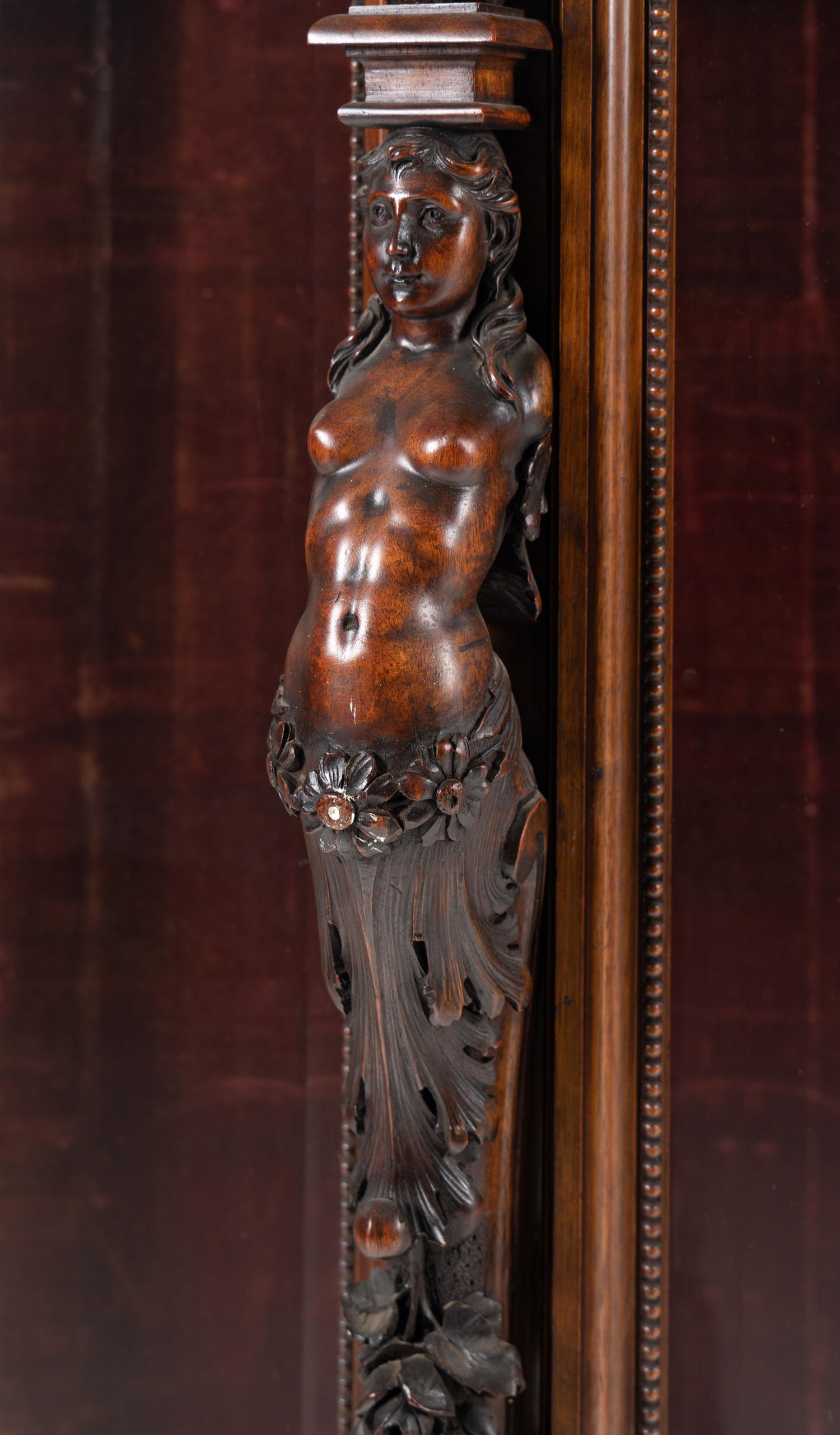 An Italian Renaissance Revival Carved Walnut Cabinet