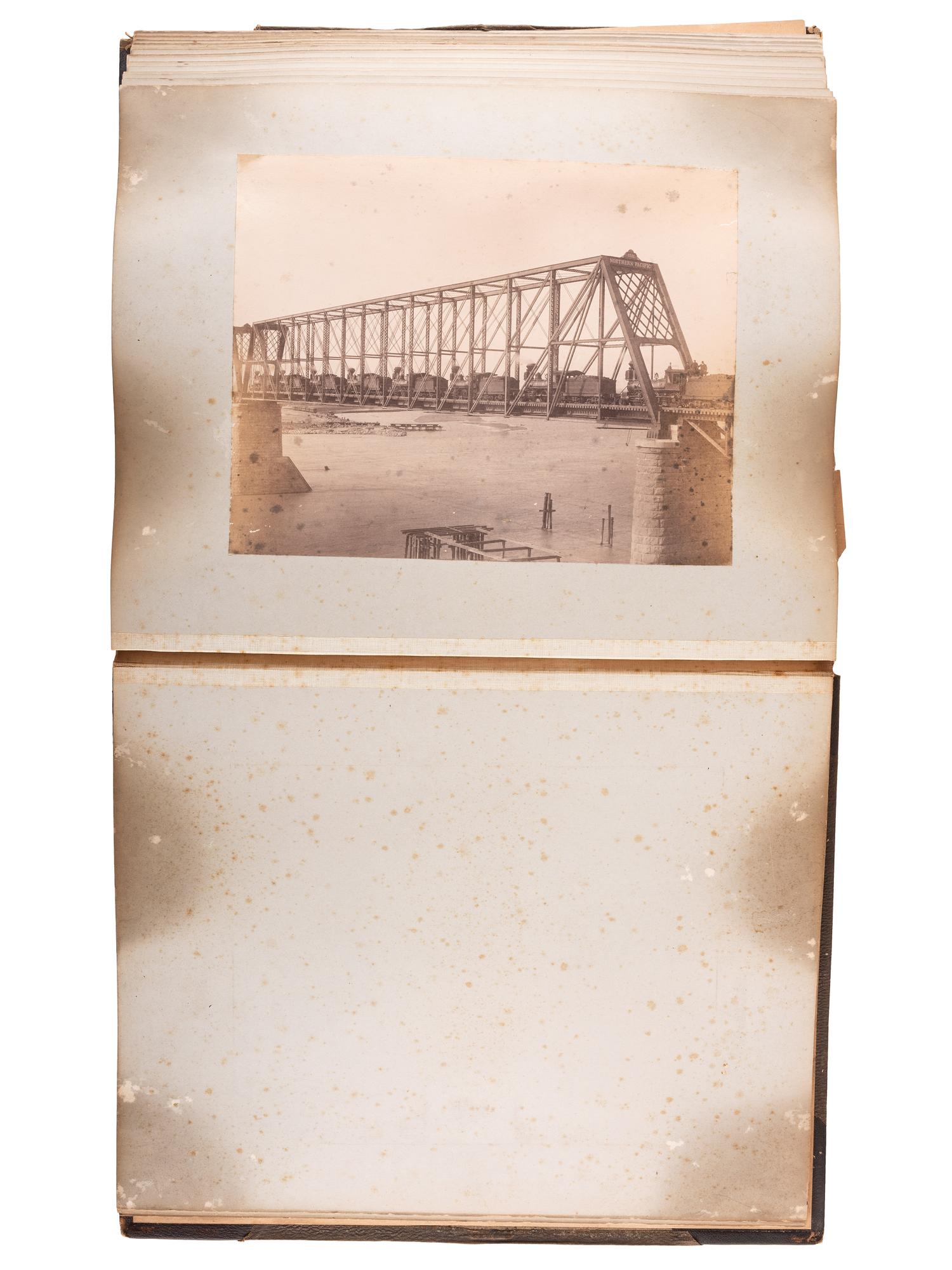 [WESTERN AMERICANA]. Album of photographs showing the construction of the "Bismarck Bridge." [Dakota Territory]: [F. Jay Haynes], [1882].