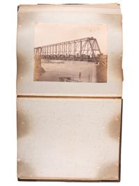 [WESTERN AMERICANA]. Album of photographs showing the construction of the "Bismarck Bridge." [Dakota Territory]: [F. Jay Haynes], [1882].