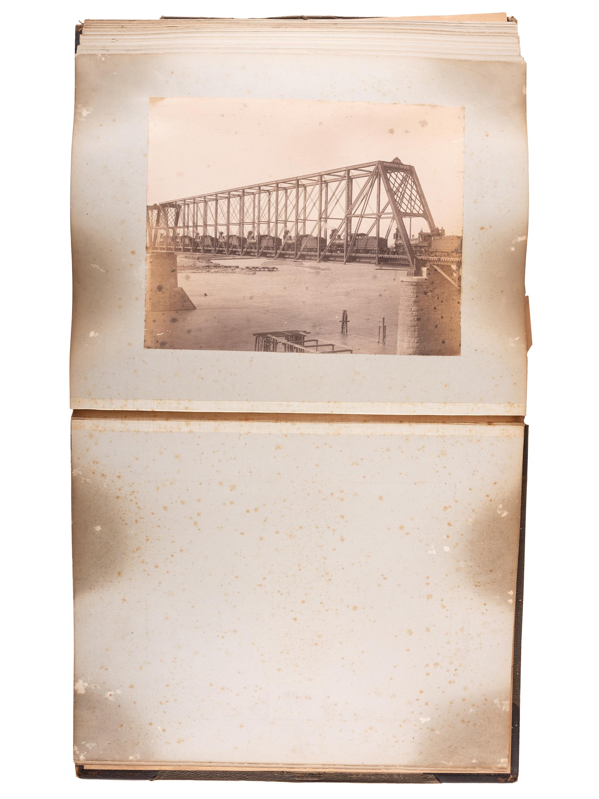 [WESTERN AMERICANA]. Album of photographs showing the construction of the "Bismarck Bridge." [Dakota Territory]: [F. Jay Haynes], [1882].