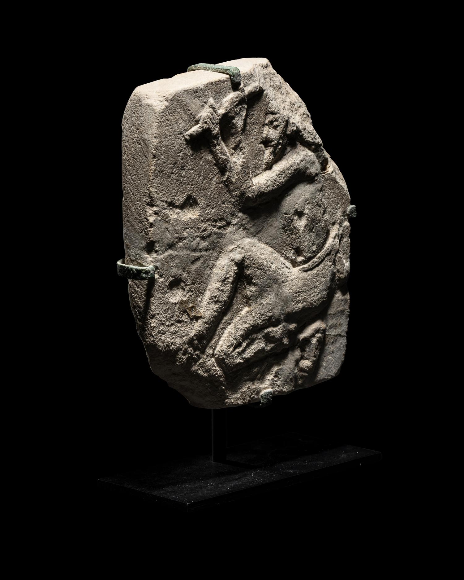 An Egyptian Limestone Relief of a Sculptor