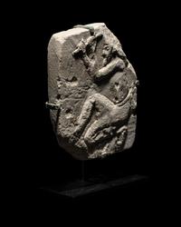 An Egyptian Limestone Relief of a Sculptor